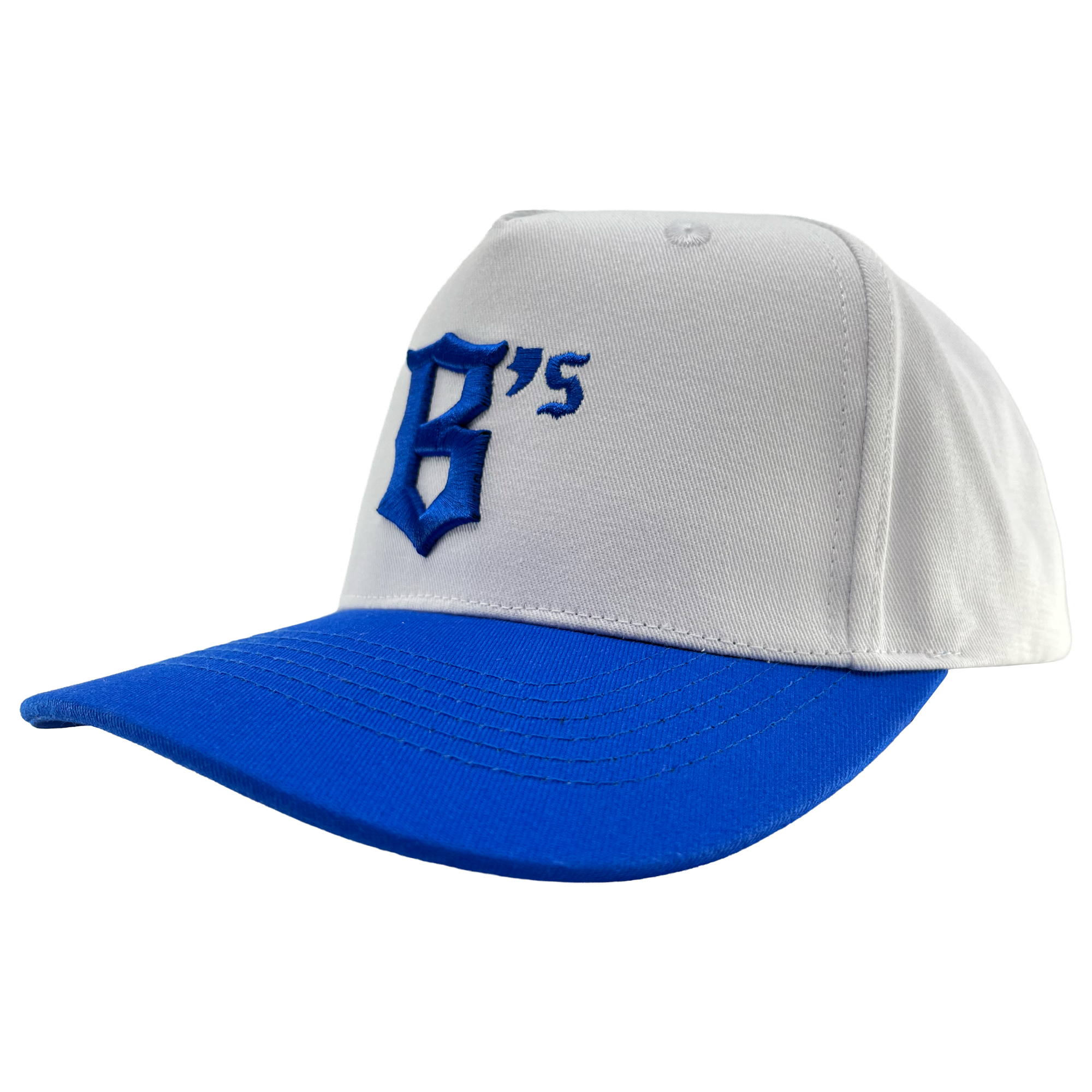 The Oakland Ballers 5 Panel Cap is a white snapback hat with a royal blue brim. The front showcases a bold, stylized blue “B” alongside a small blue “‘s,” representing the Oakland Ballers. The background of the cap is plain white.