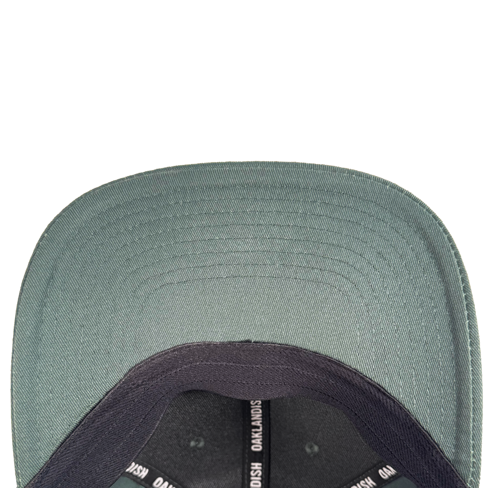 Close-up, top-down view of the underside of the Oakland Ballers Script Snapback's green brim. The inner band features the Oakland Ballers brand name, while a white background highlights detailed stitching.
