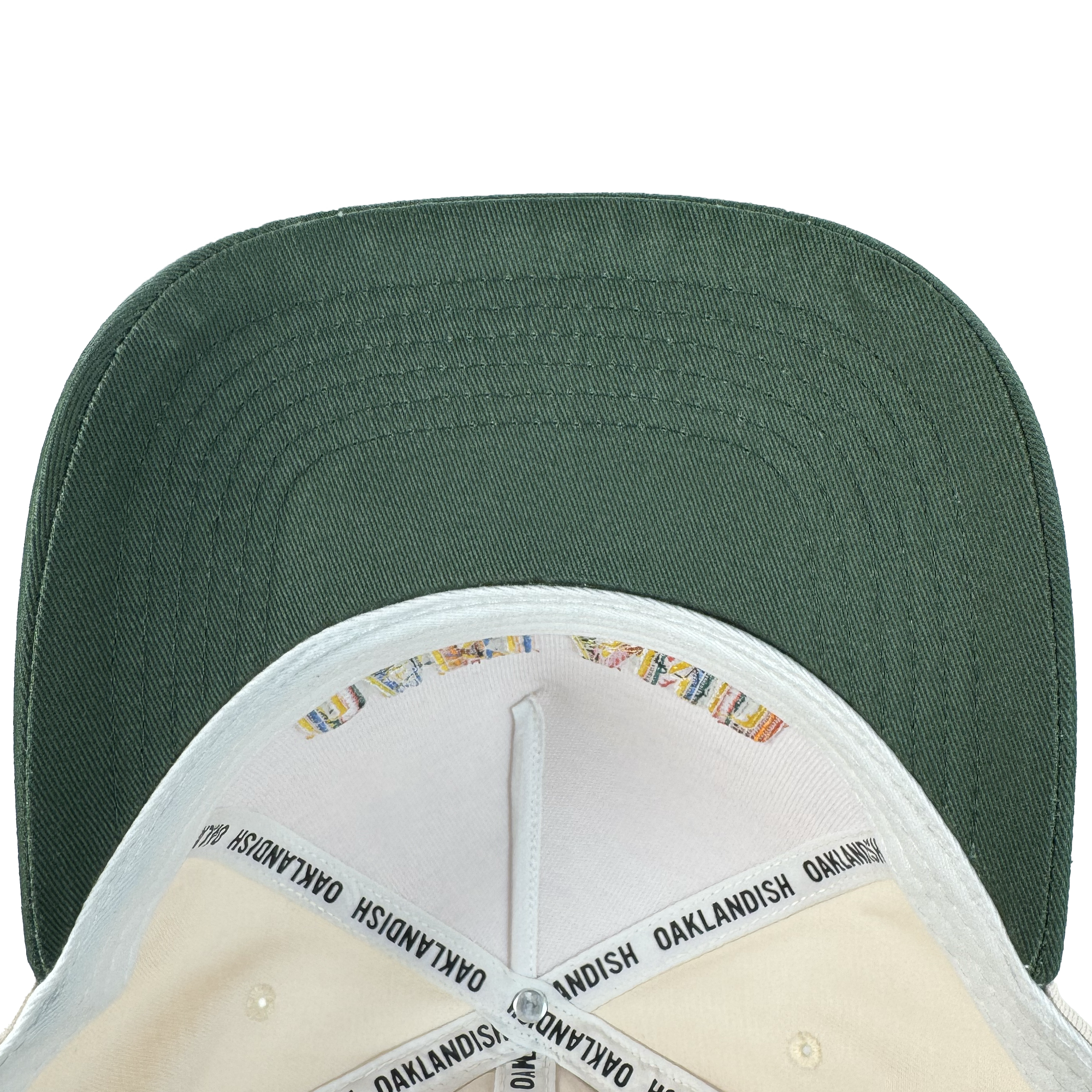 A top-down view of the Oakland Ballers Oakland Beisbol 5 Panel Cap shows its green brim, cream crown interior, black "OAKLANDISH" inner band, colorful stitching, and classic snapback style—ideal for any fan.