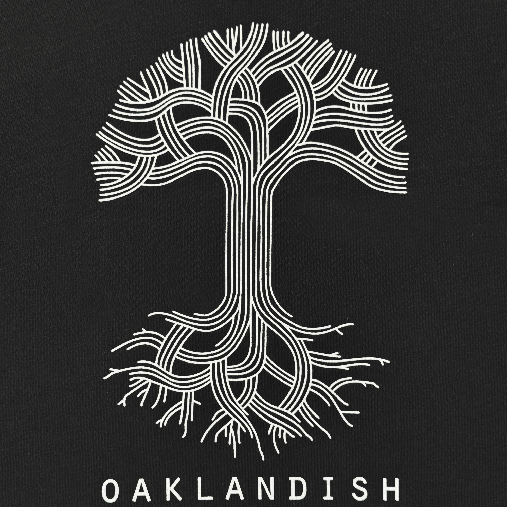 The Women’s Oaklandish Logo V-Neck by Oaklandish features a stylized white tree with interwoven branches and roots, “OAKLANDISH” in all-caps below, and is crafted from 100% cotton.