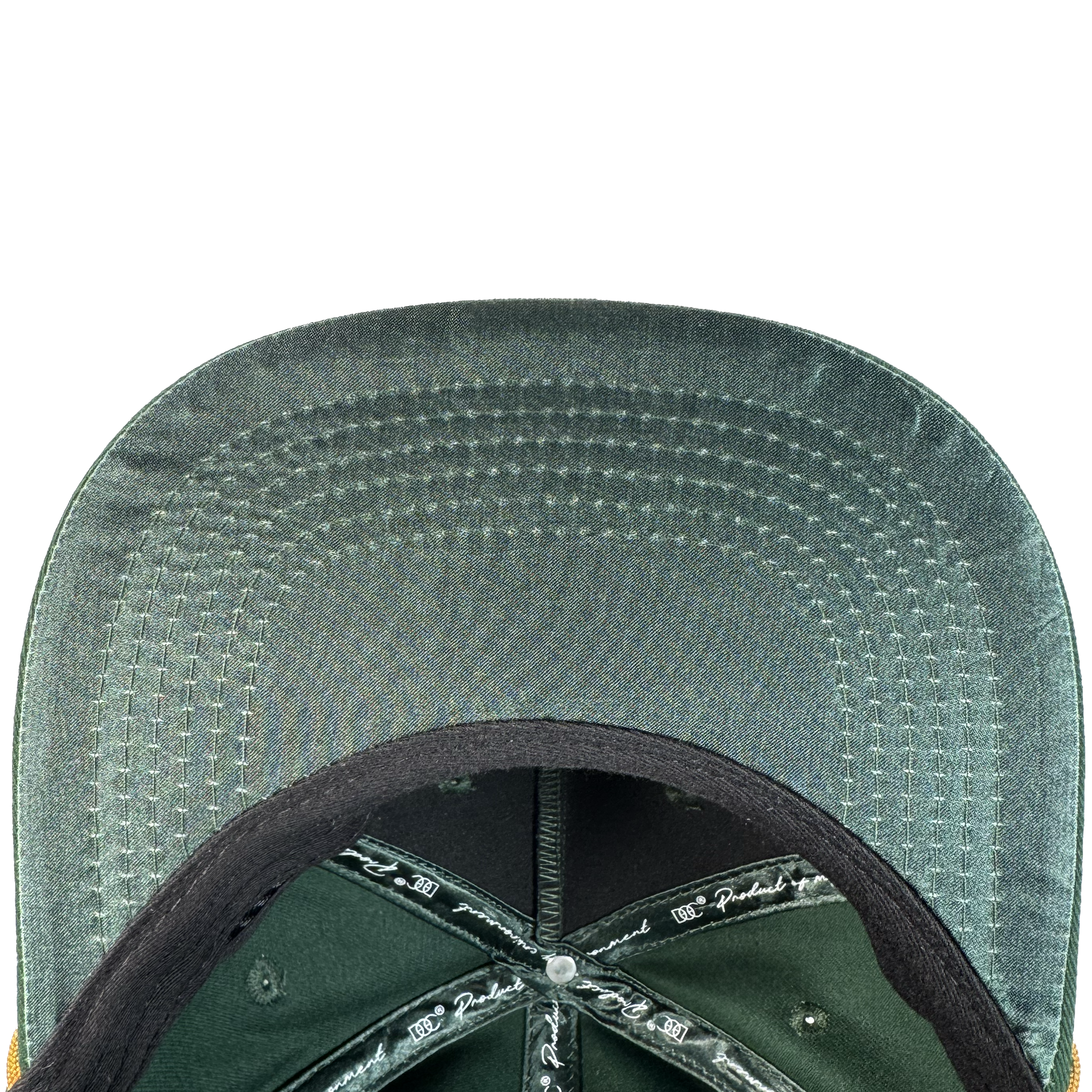 Close-up of the Bay Area 5 Panel By DOC by Oaklandish: shows the underside of its green brim with neat parallel stitching, black interior lining featuring white printed text, and a silver button at the crown center.