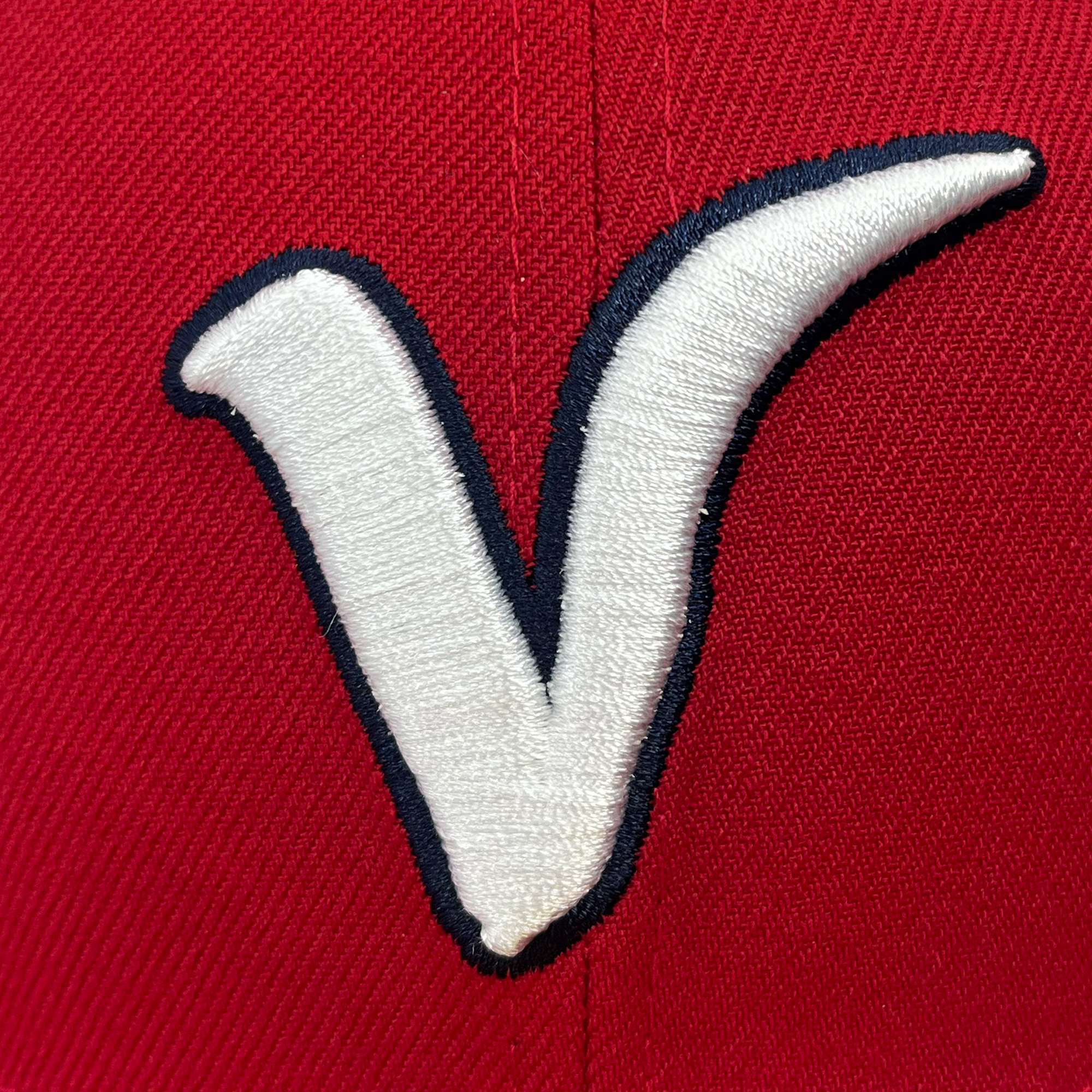 Detailed view of red New Era 59fifty fitted hat with Away El Aguila logo & red bill.