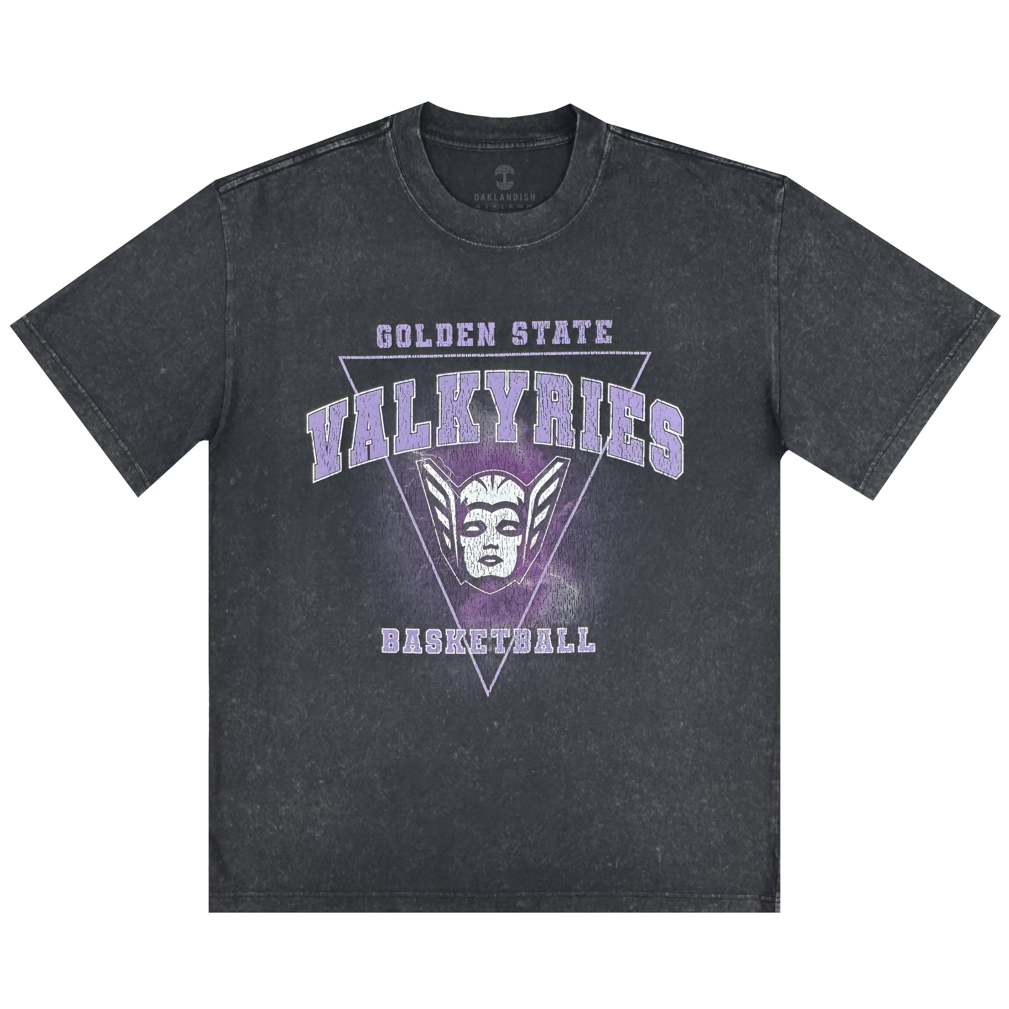The GSV Golden State Valkyries Surge Stone Wash Heavy Tee is a black acid-wash shirt with "Golden State Valkyries Basketball" in white and purple, a stylized Valkyrie mask and purple triangle on the front. Made from soft organic cotton, with short sleeves and a relaxed fit.
