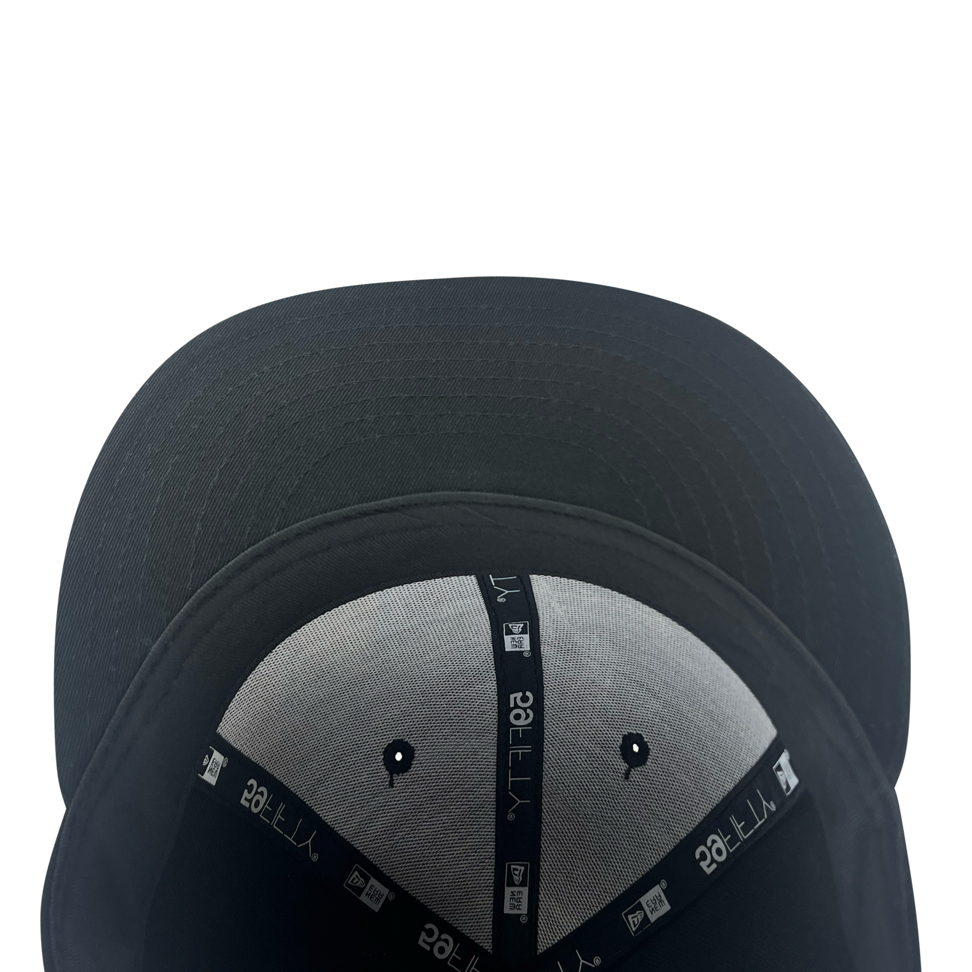 A New Era Pericos ALT 59FIFTY Cap by Retail Vendors is displayed from an overhead perspective, focusing on its inner lining. The grey lining with black seams features white text and symbols. Two small ventilated holes are visible near the top of the image, while the brim of this cap remains black.