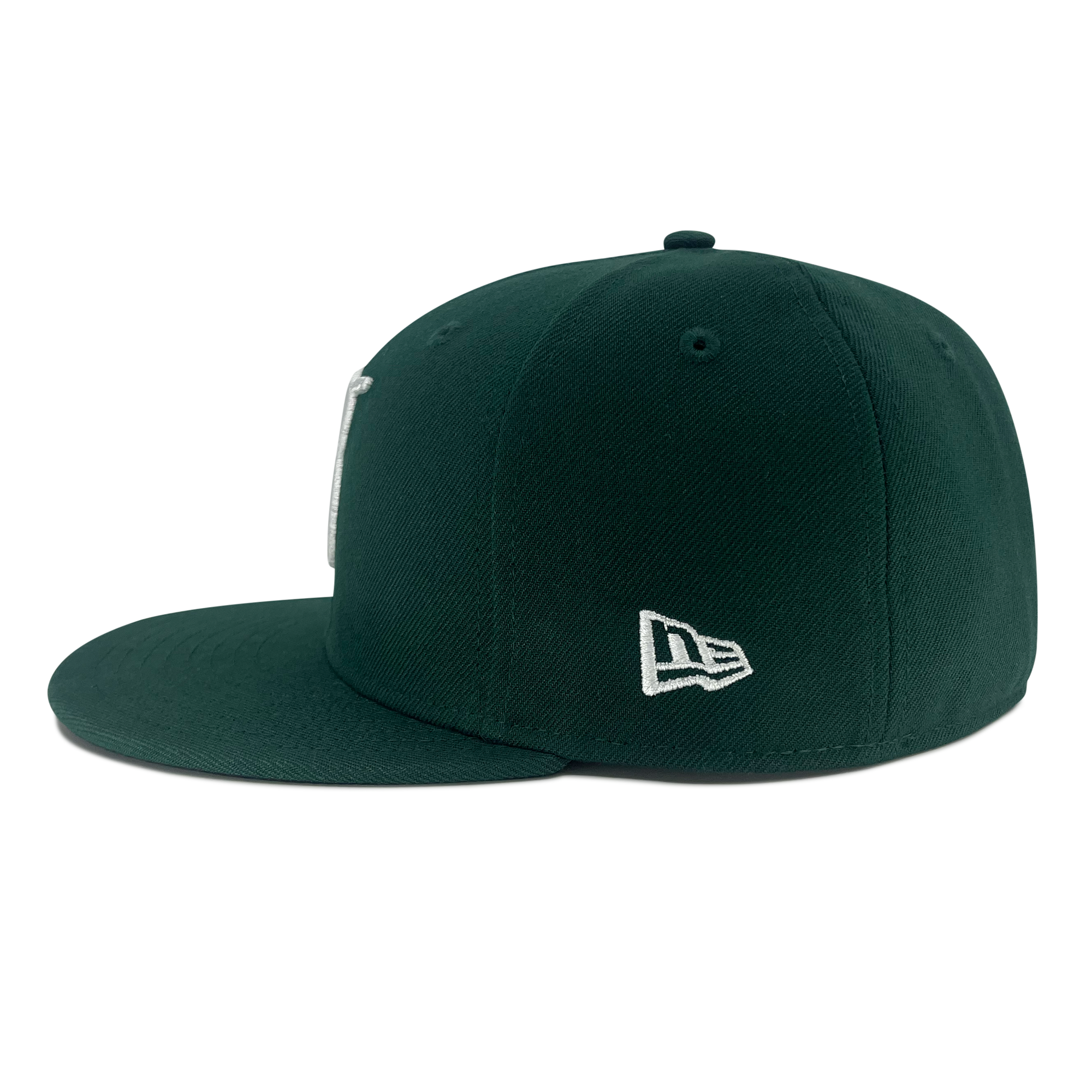 Left side view of forest green 59fifty fitted hat with New Era flag logo on wearer's left side.