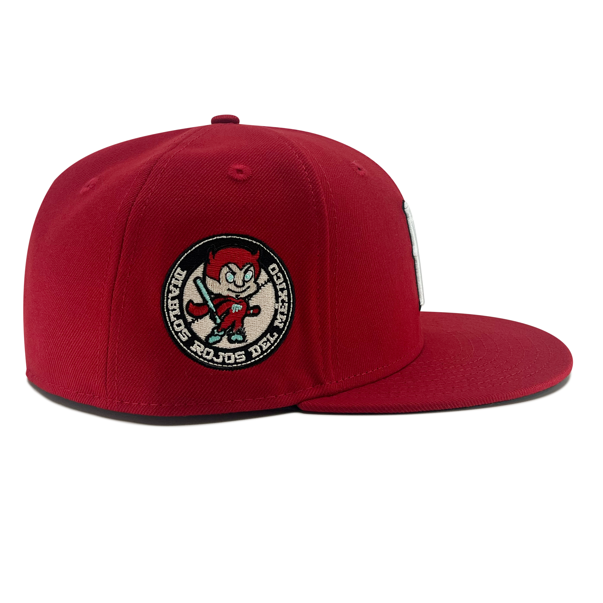 Right side view of red diablos 59fifty fitted hat with Diablos patch on wearer's right.