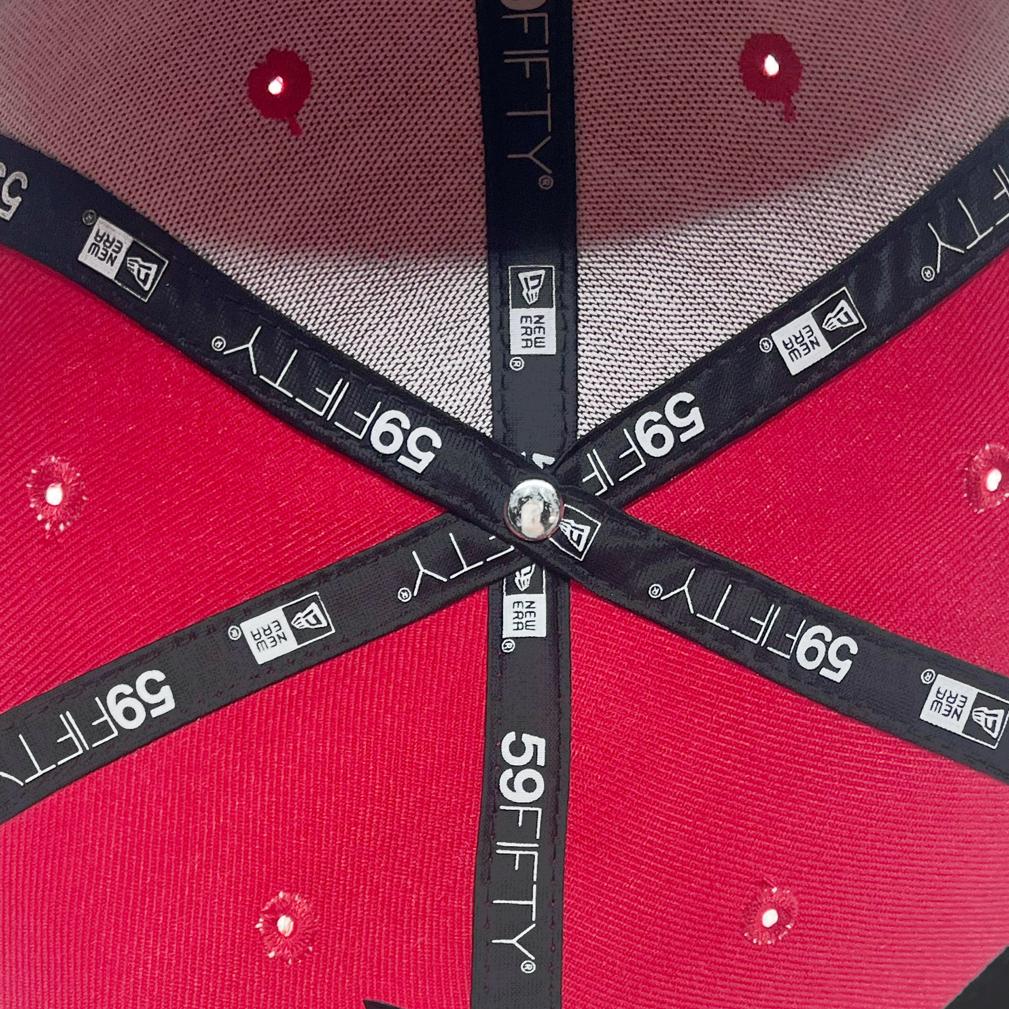 Detailed inside view of red 59fifty fitted hat with 59Fifty and New era logos on taping.