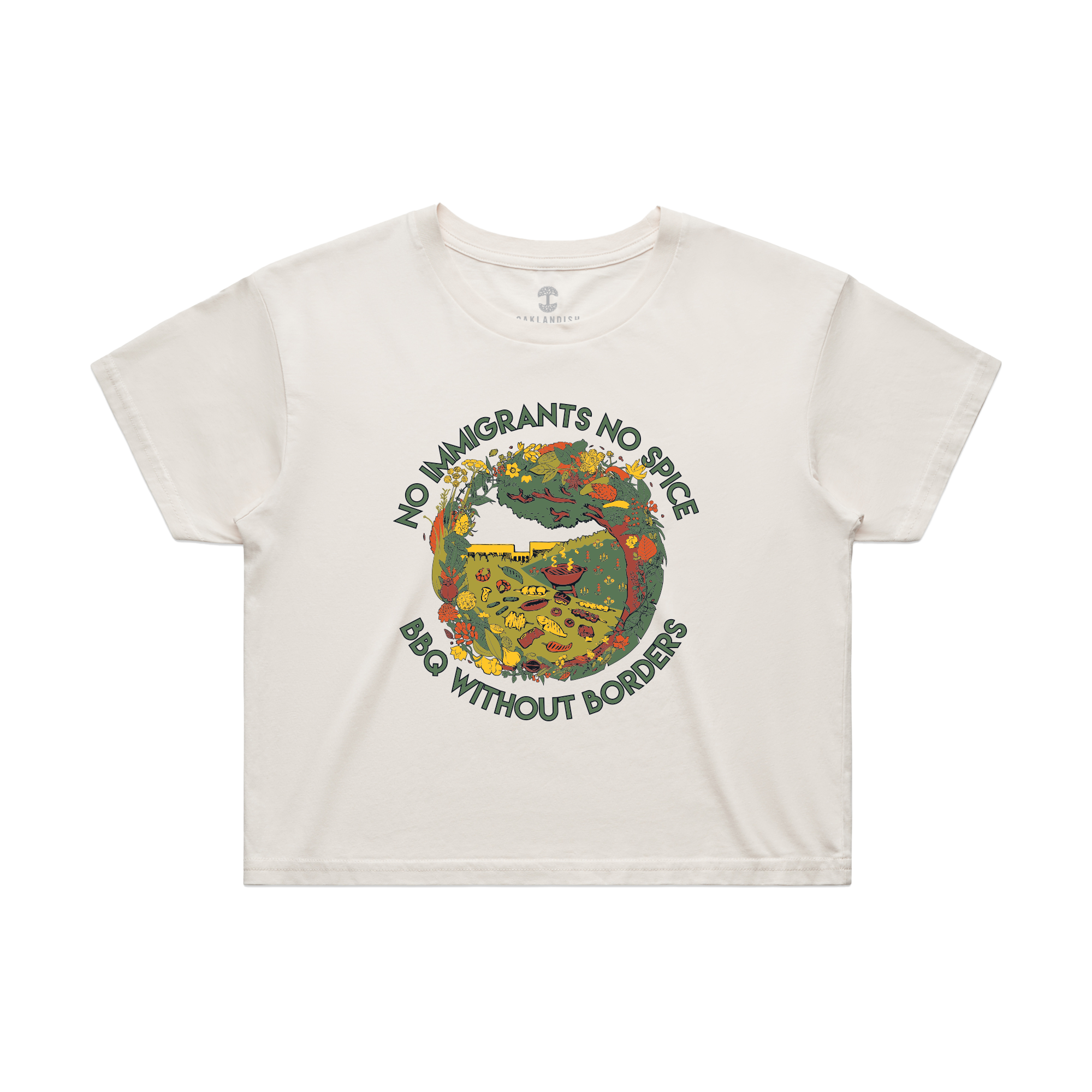 The Oaklandish Women's NINS Spice Bloom Crop Tee is a cream-colored limited edition top with a vibrant food prep scene around a grill and green “No immigrants no spice, BBQ Without Borders” text above and below the image.