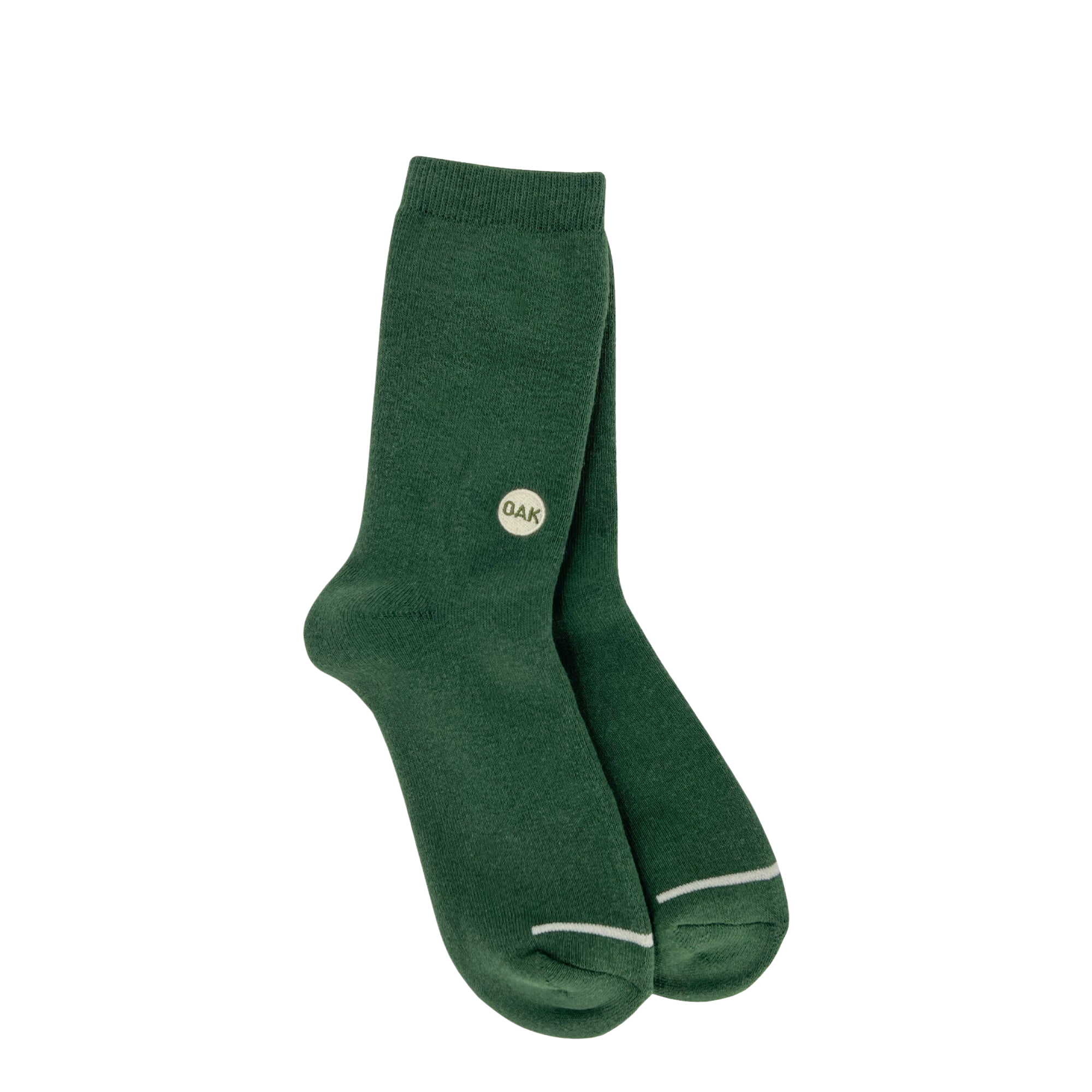 A pair of Oaklandish Plush Oak Socks in dark green is showcased against a plain white background. Each sock is adorned with a small circular Oak logo marked with the letters "QAK" near the top outer side. These plush socks feature a subtle white outline at the toe area and have a ribbed cuff at the top, ensuring happy feet all day long.