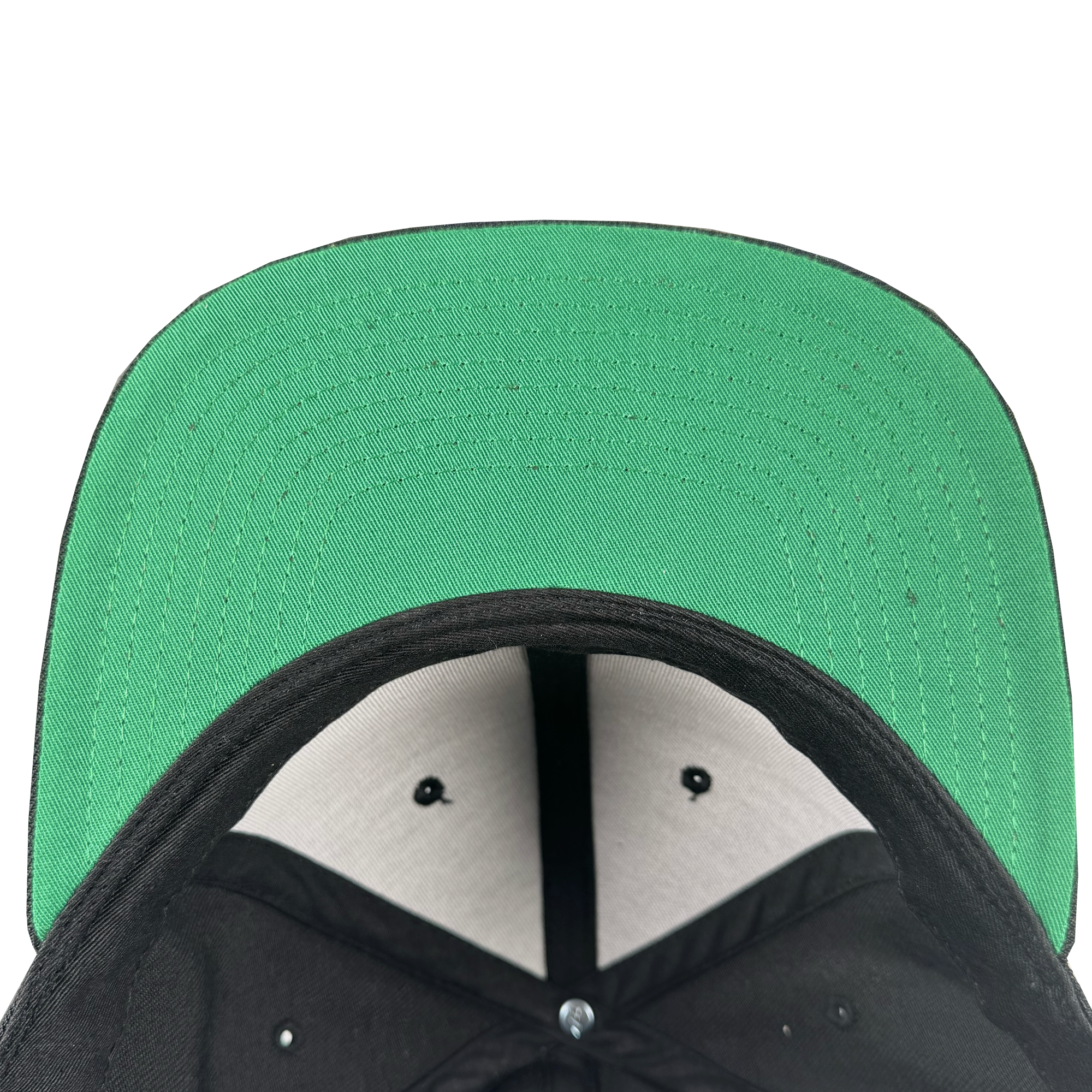 Close-up view of the underside of the Power of the People Snapback by Oaklandish, featuring a black crown, green flat brim, black and white paneling, visible stitching, and ventilation holes for modern streetwear style.