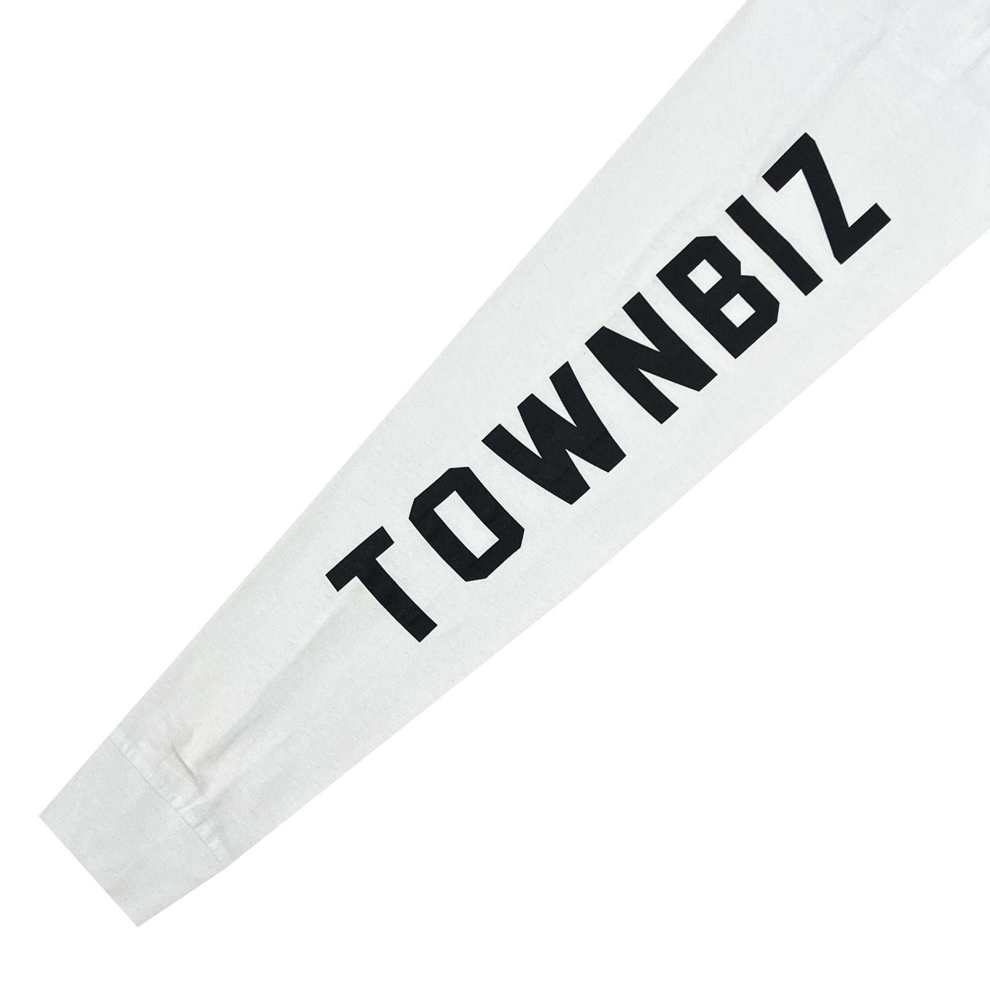 Close-up of the sleeve of an Oakland Roots SC Classic 2.0 LS Tee, showcasing the text "TOWNBIZ" in bold black capital letters printed vertically along the length of the smooth white fabric. The clearly legible text runs along the forearm section, celebrating Oakland Roots Sports Club’s vibrant sports culture.