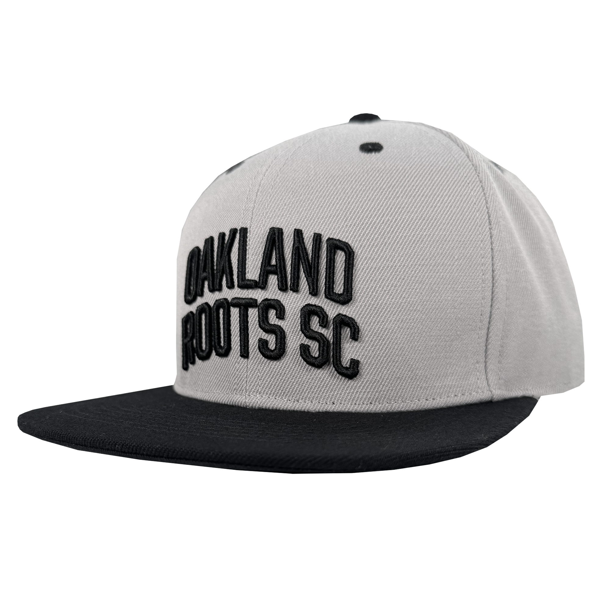 The Oakland Roots SC Arch Text Snapback by Oakland Roots SC is a light gray cap with a flat black brim and bold, raised black "OAKLAND ROOTS SC" text on the front panel, shown at a left angle against a white background.