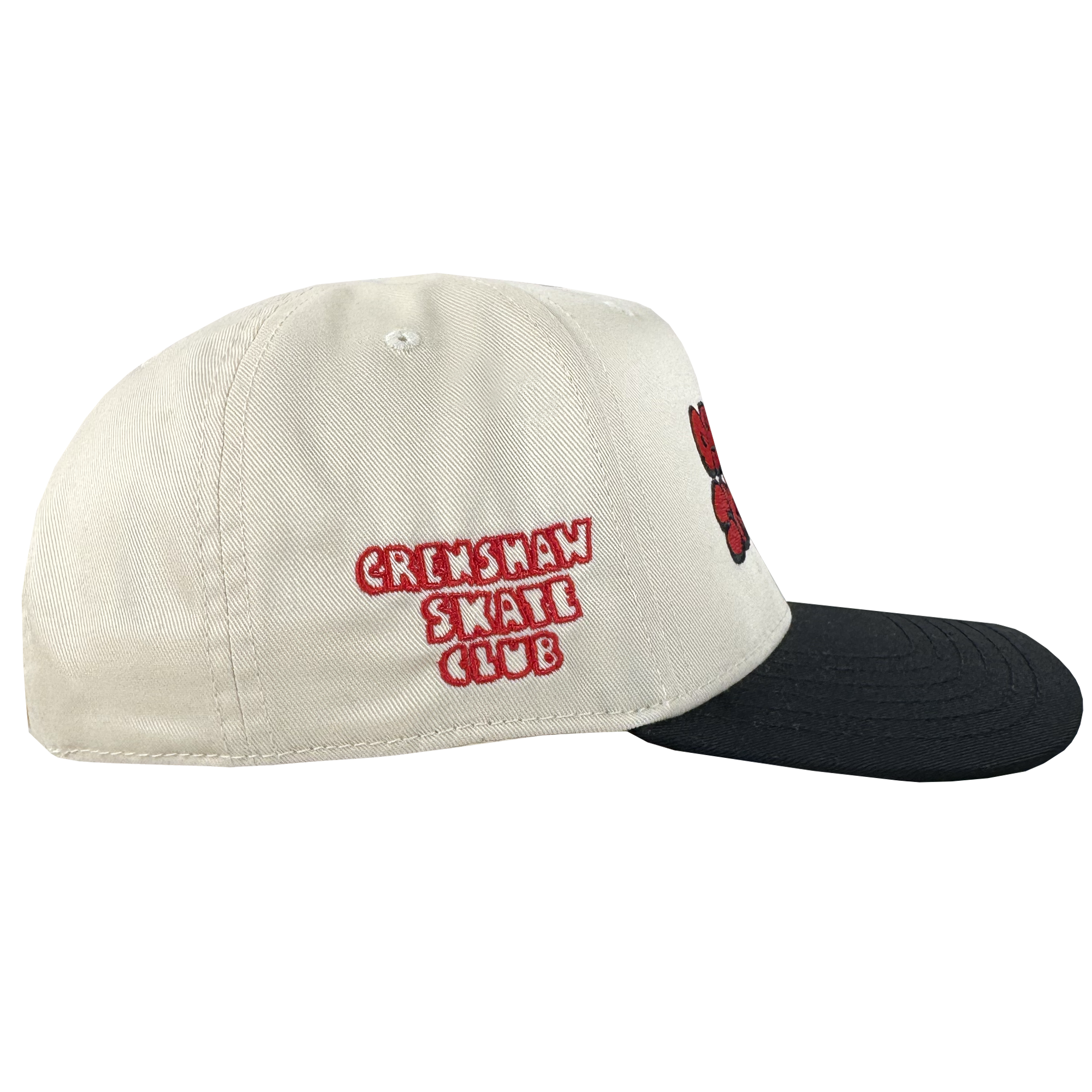The Oaklandish Skate Club 2-Tone Hat, by Oaklandish, features a beige crown with a black brim. Red and white embroidery on the side highlights skate culture, while a red and black design accents the front. Shown against a plain white background.