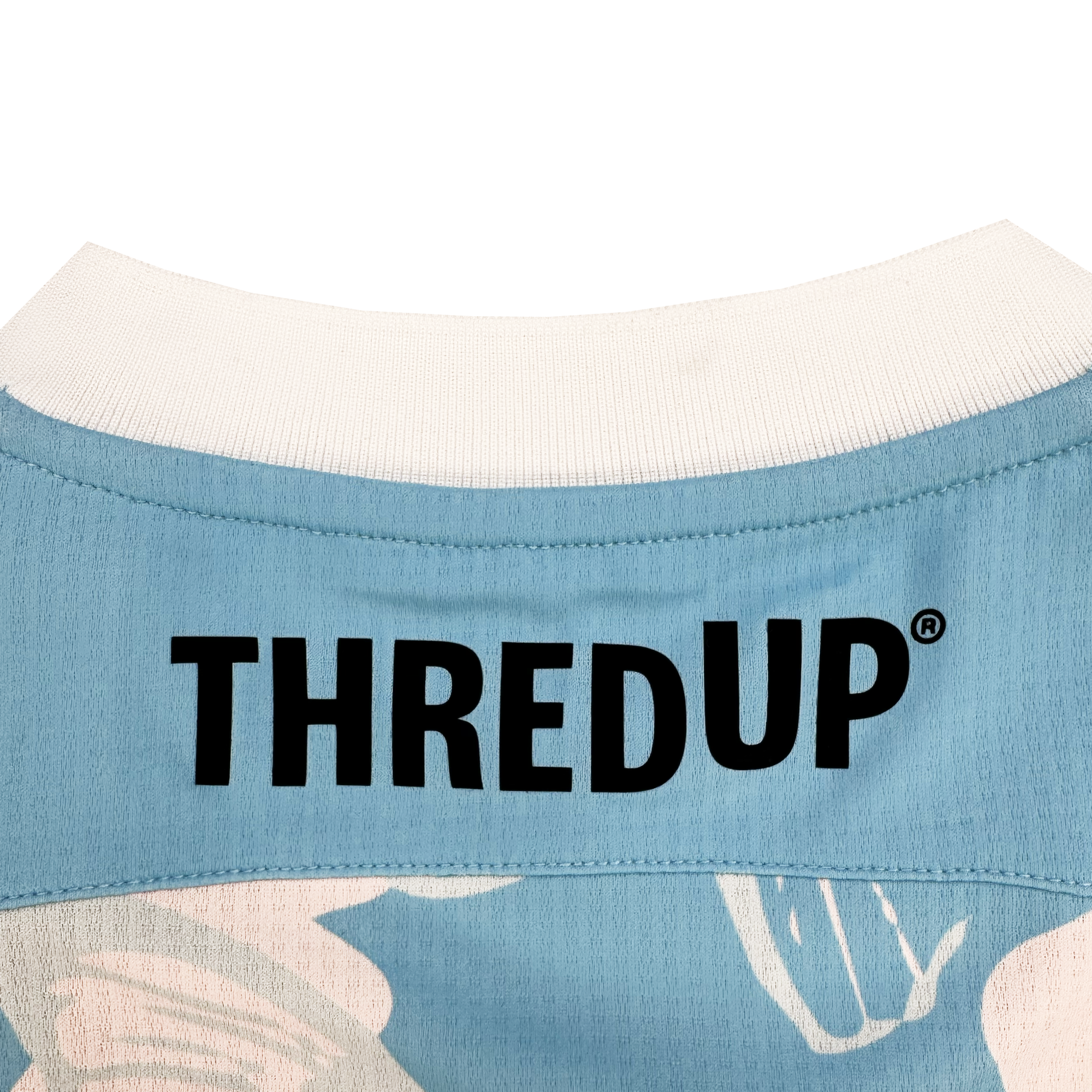 Close-up of the back neck area of a blue Oakland Soul Unisex Butterfly Effect Kit shirt with a white collar. "THREDUP" in bold black letters is printed across the upper back, with white and pale pink abstract butterflies below.