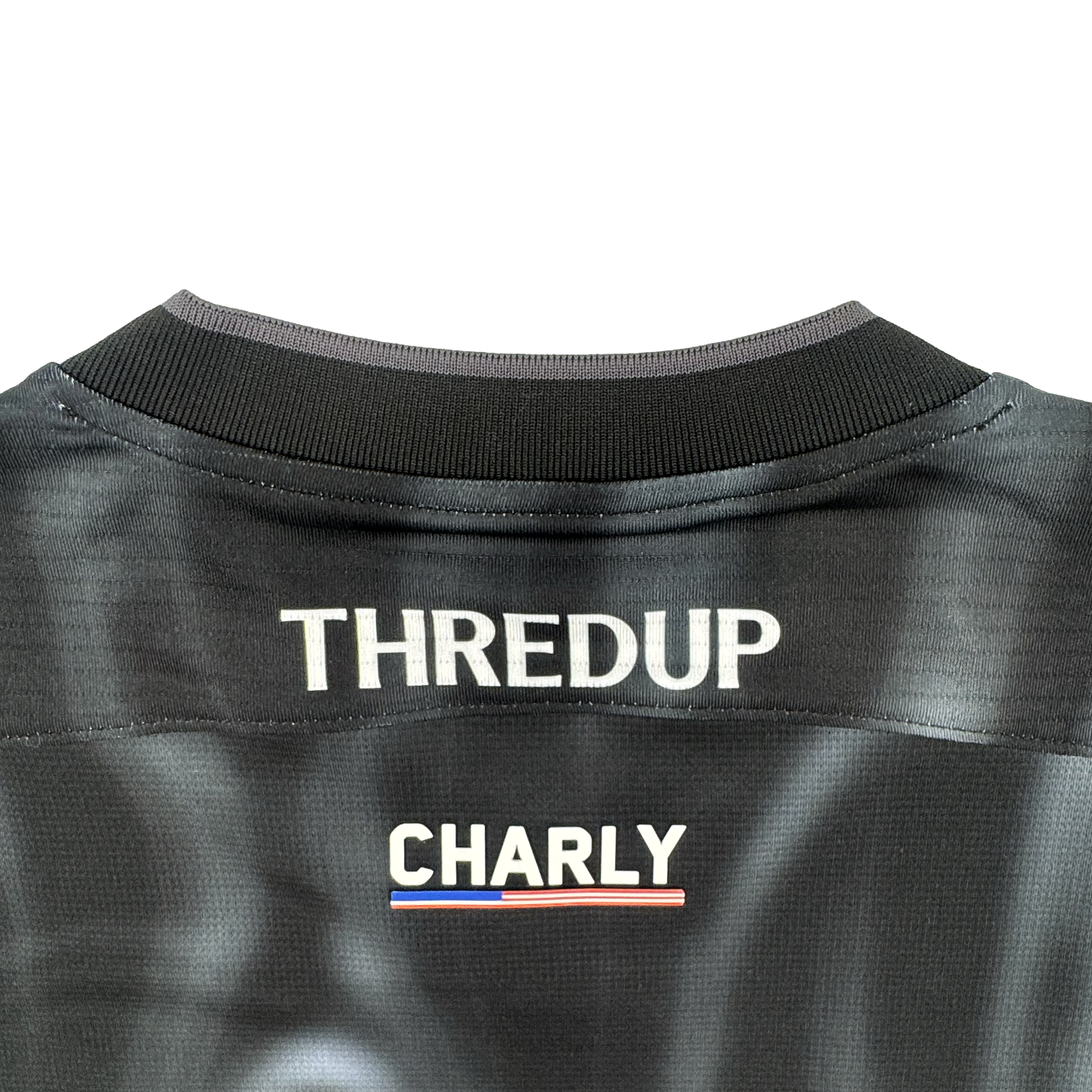 The image displays the upper back of a black Custom 2026 OAKLAND SOUL SC SPIRIT JERSEY by Oakland Soul. "THREDUP" appears in bold white at the top, above "CHARLY" and a small red, white, and blue stripe. The background is light gray.