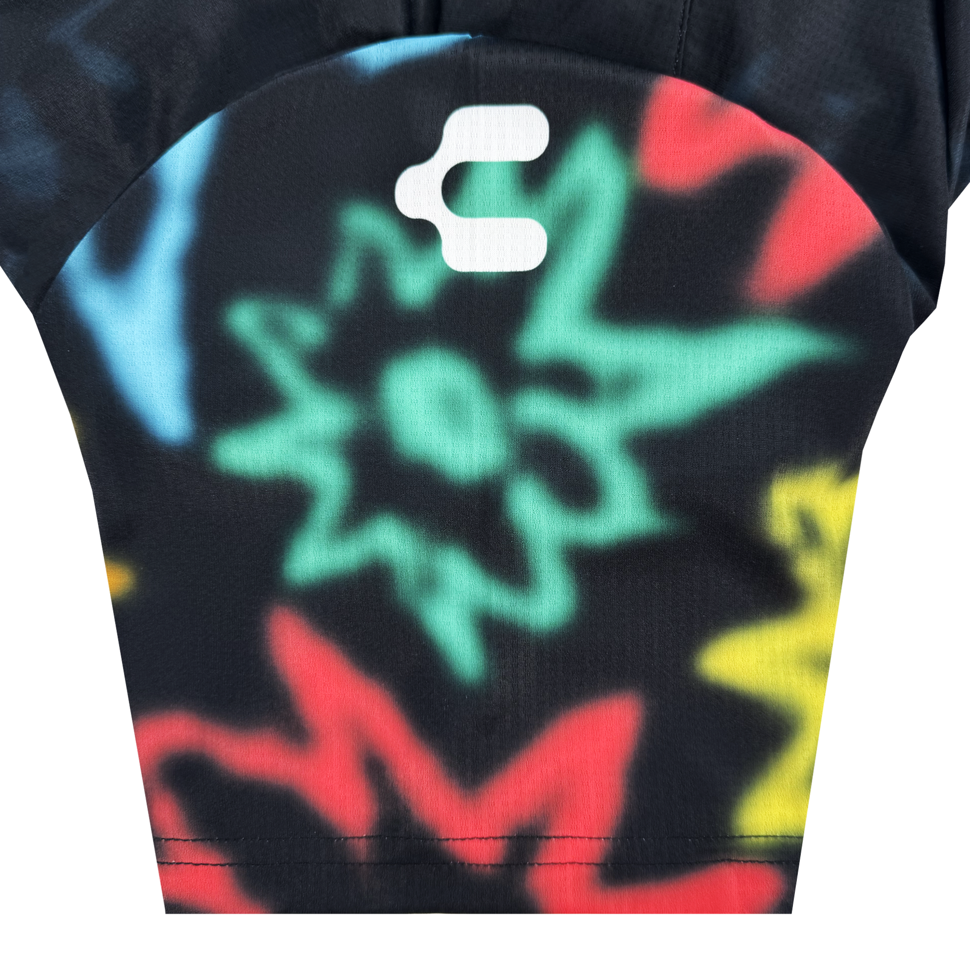 A close-up of the Custom Unisex Soul Bloom Kit by Oakland Soul shows black fabric with vibrant starburst patterns in green, red, yellow, and blue, featuring a white "c" at the top center symbolizing transformation and Oakland roots.