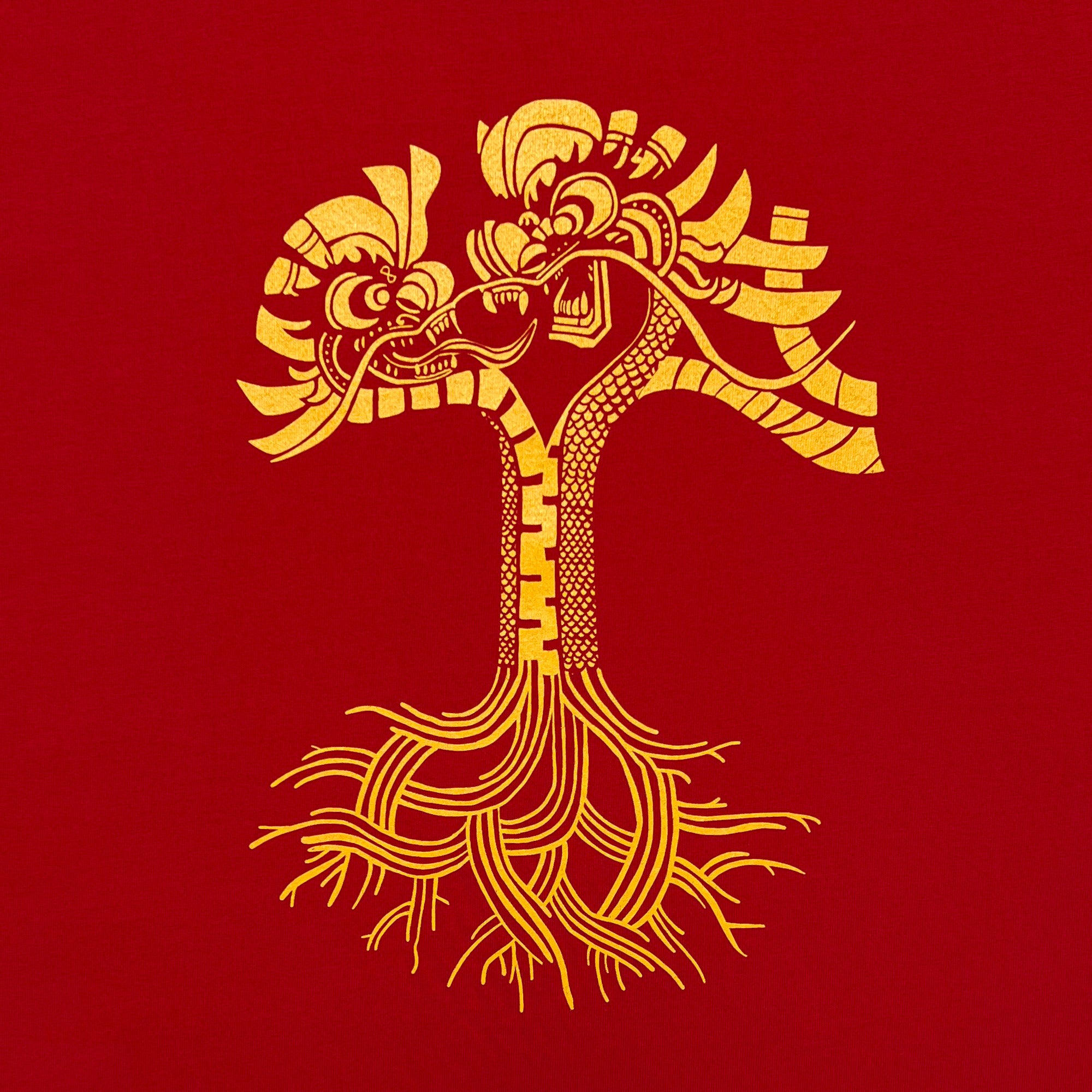 The Dragon Power Tee by Oaklandish boasts a stylized graphic on a red background, showcasing two golden dragons intricately intertwined into a single tree trunk. Celebrating Oakland Chinatown and Chinese American heritage, the design features detailed scales, wings, and roots that blend natural and mythical elements seamlessly.
