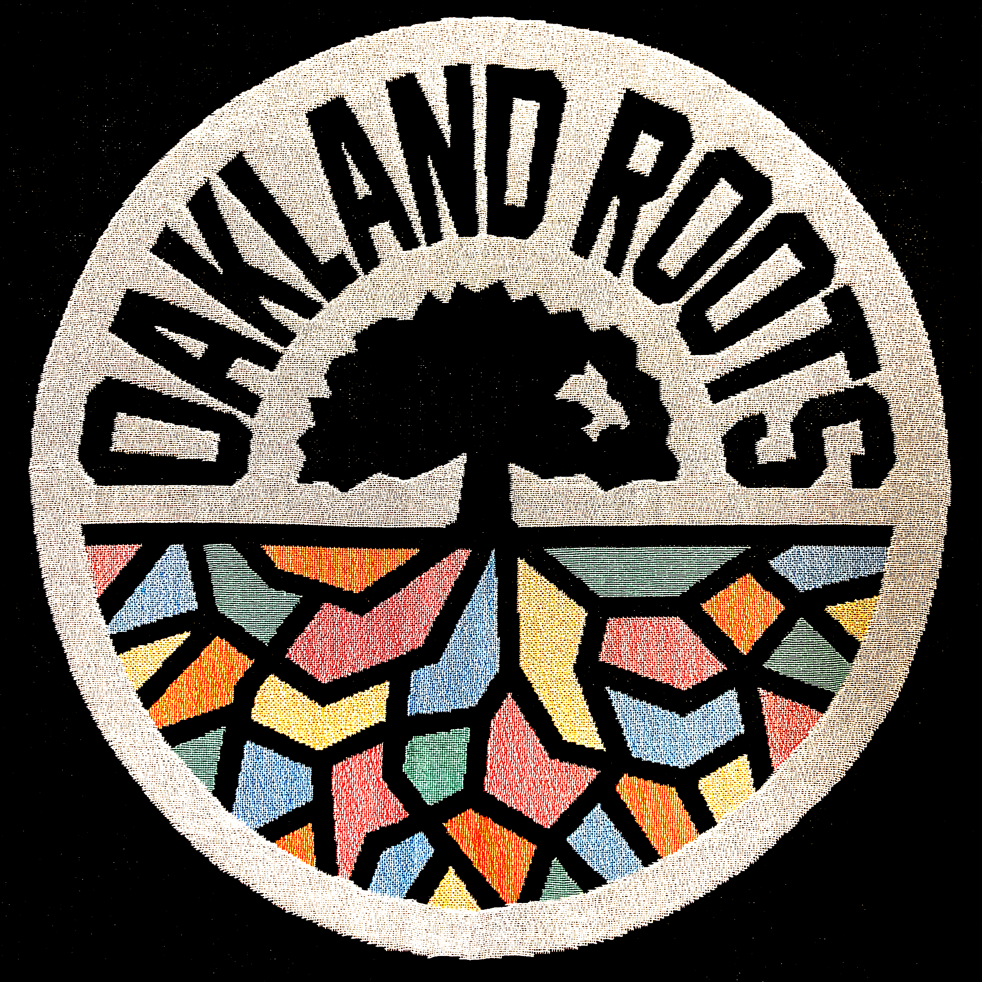 Circular emblem featuring a black tree silhouette with "Oakland Roots SC" in bold black letters curving around the top. The bottom half includes colorful, mosaic-like segments resembling roots, in shades of orange, yellow, blue, and green. The background is white. This design is featured on the Oakland Roots SC Throw by Oakland Roots SC.