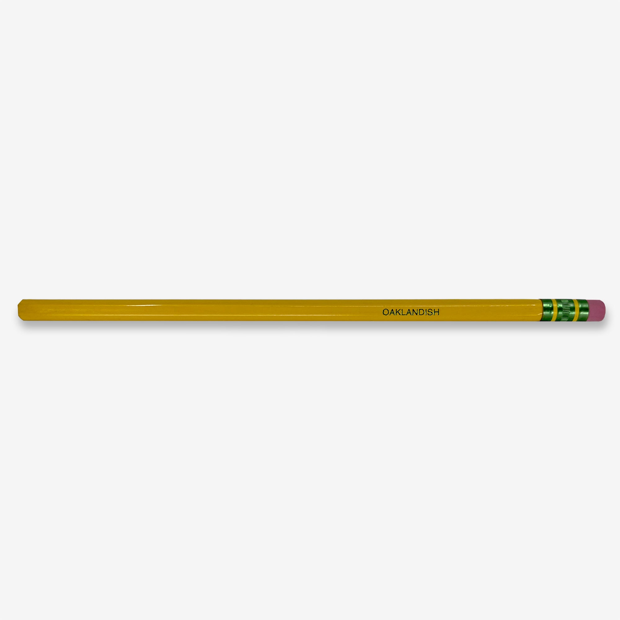 The Oaklandish Pencil Dixon Ticonderoga No. 2 is a classic yellow wooden pencil featuring a latex-free pink eraser secured by a gold-colored metal band with green accents. "OAKLANDISH" is printed in bold black letters near the eraser end, and the pencil is renowned for its extra smooth writing. The unsharpened end of the pencil stands out against a white background.