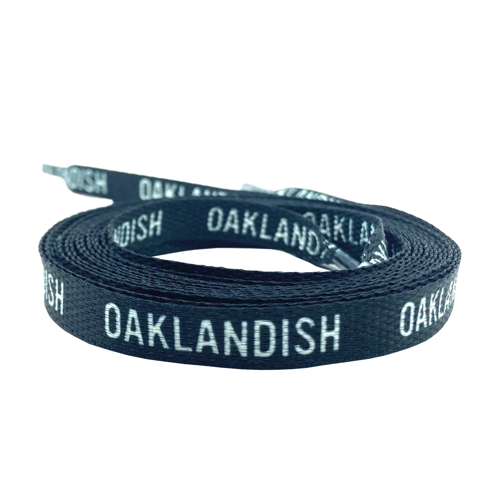 The Wordmark Shoelaces by Oaklandish, made from 100% polyester and featuring a woven texture, are displayed coiled against a white background. These flat black shoelaces have the text "OAKLANDISH" repeatedly printed in white and include standard tipped ends.