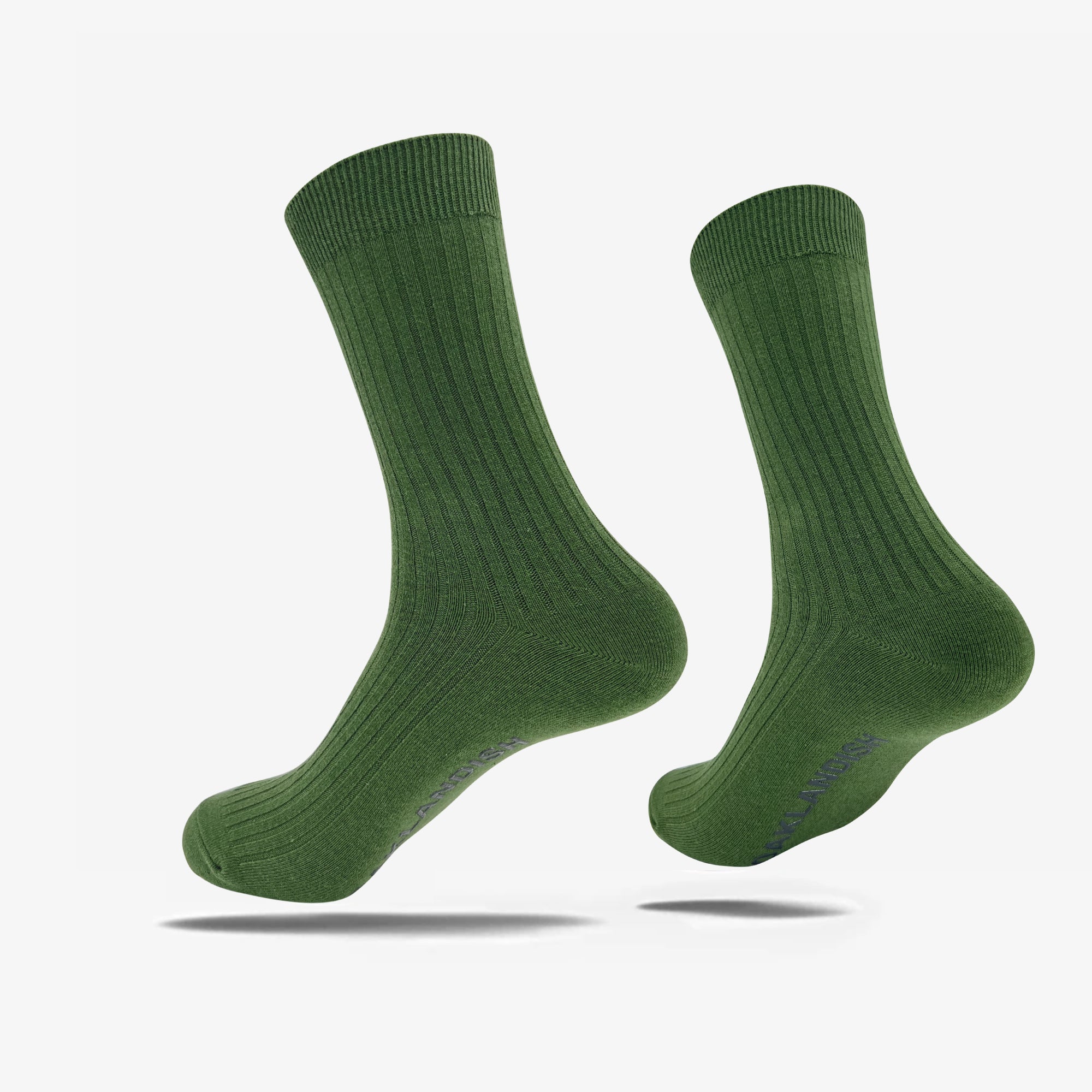 Two forest green Oaklandish Grip Crew Socks are displayed, slightly tilted to the left. The socks feature a textured, vertical ribbed design extending from the ankle to the top cuff. The bottom of one sock shows the brand name "Oaklandish" in small, dark writing. One size fits most. The background is plain white.