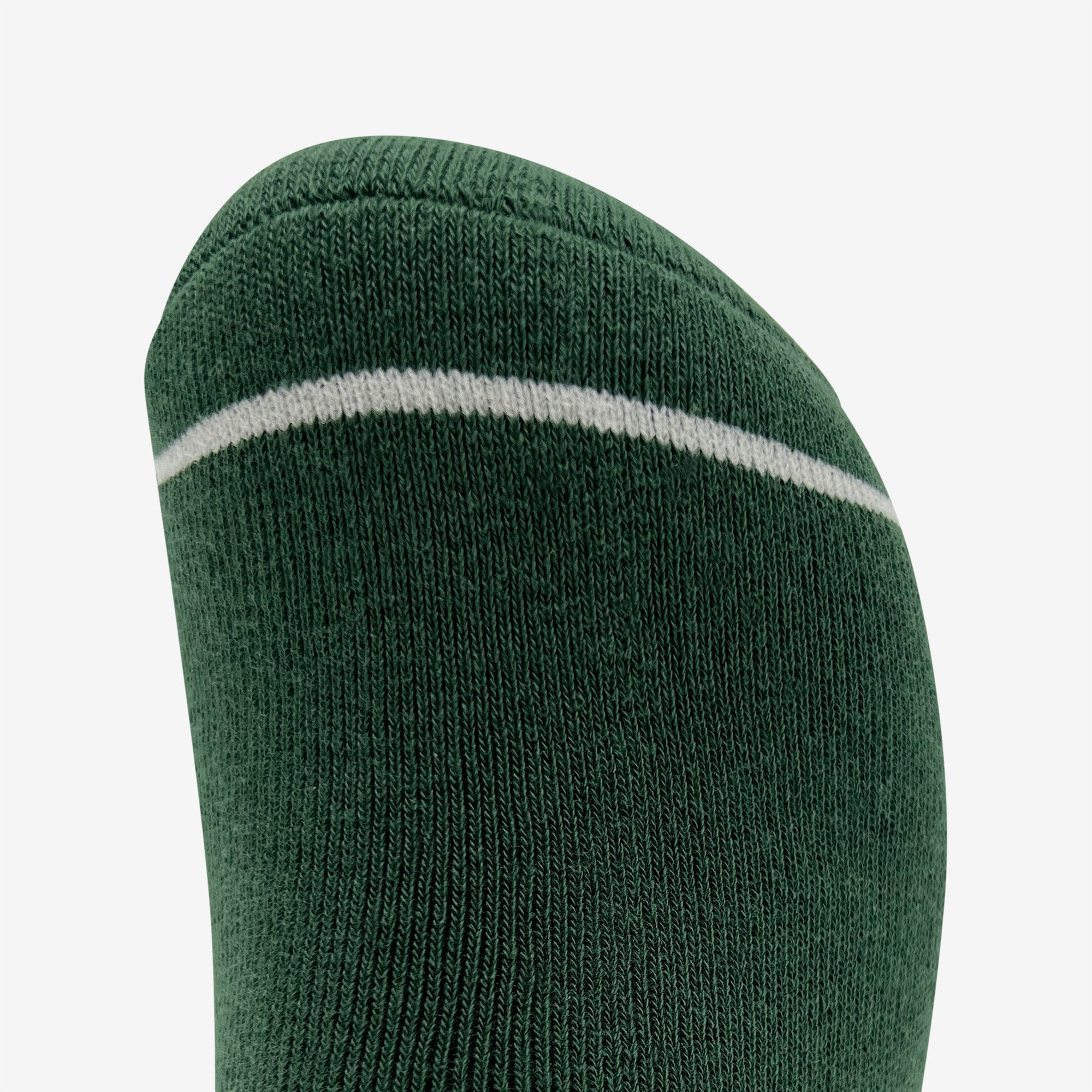 Close-up of the toe portion of a green Plush Oak Sock by Oaklandish, featuring a thin white stripe near the top. The texture of the knit fabric is clearly visible, and the stitching looks uniform. Made from soft cotton, these socks promise happy feet. The plain white background makes their green color stand out.