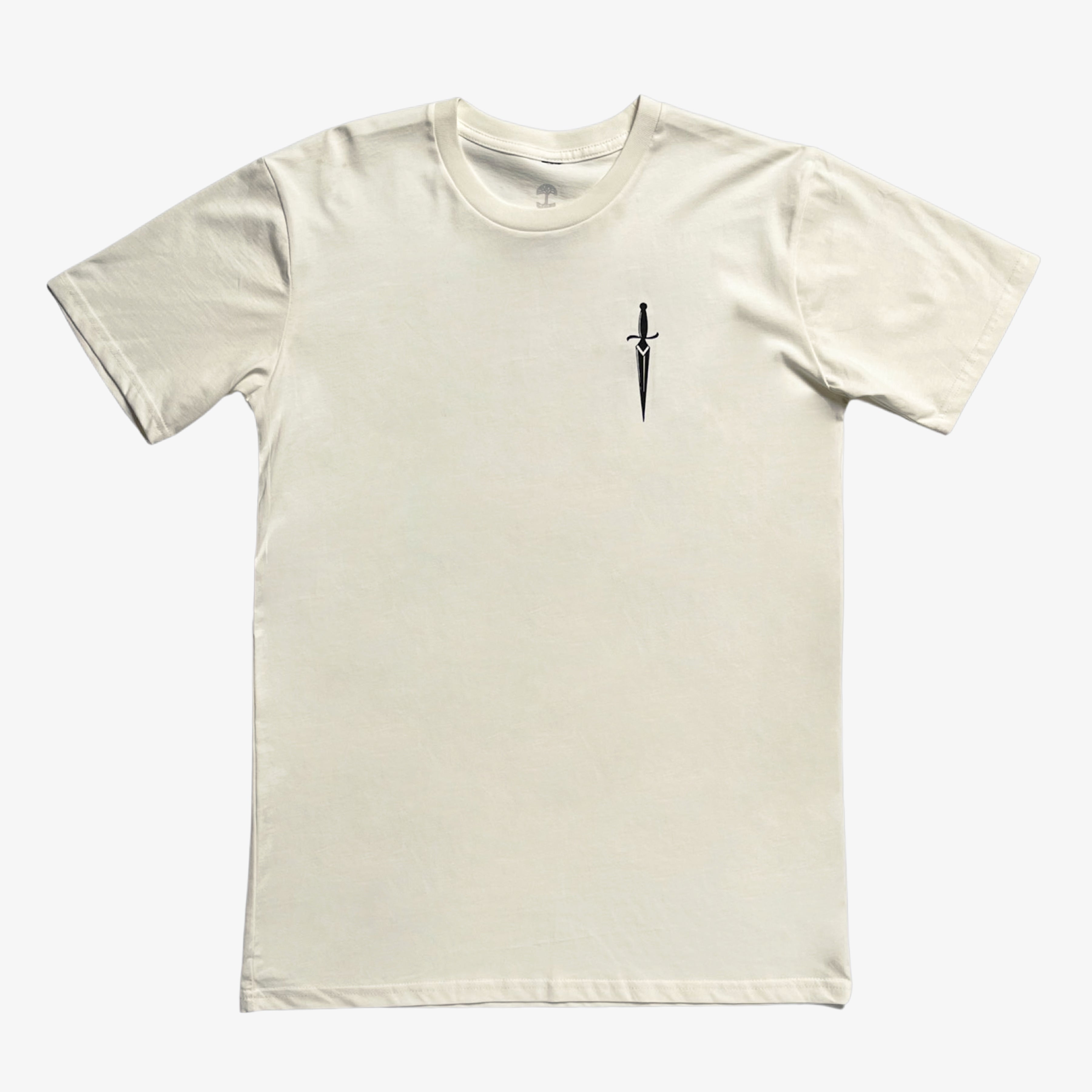 The Blossom Tee by Oaklandish is a plain, short-sleeved, cream-colored classic fit T-shirt featuring a simple design of a small black sword pointing downward on the left chest area. The sword adds a subtle accent to the otherwise clean and minimalist 100% cotton shirt.