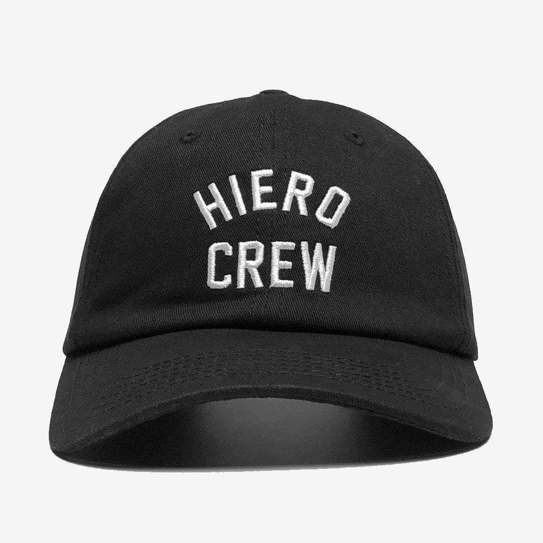 Product Description: The Hiero Crew Dad Hat by Hieroglyphics is a black cap featuring white, embroidered text on the front panel that reads "HIERO CREW" in two lines. It has a curved brim, classic unstructured design, and an adjustable strapback. The background is plain white.