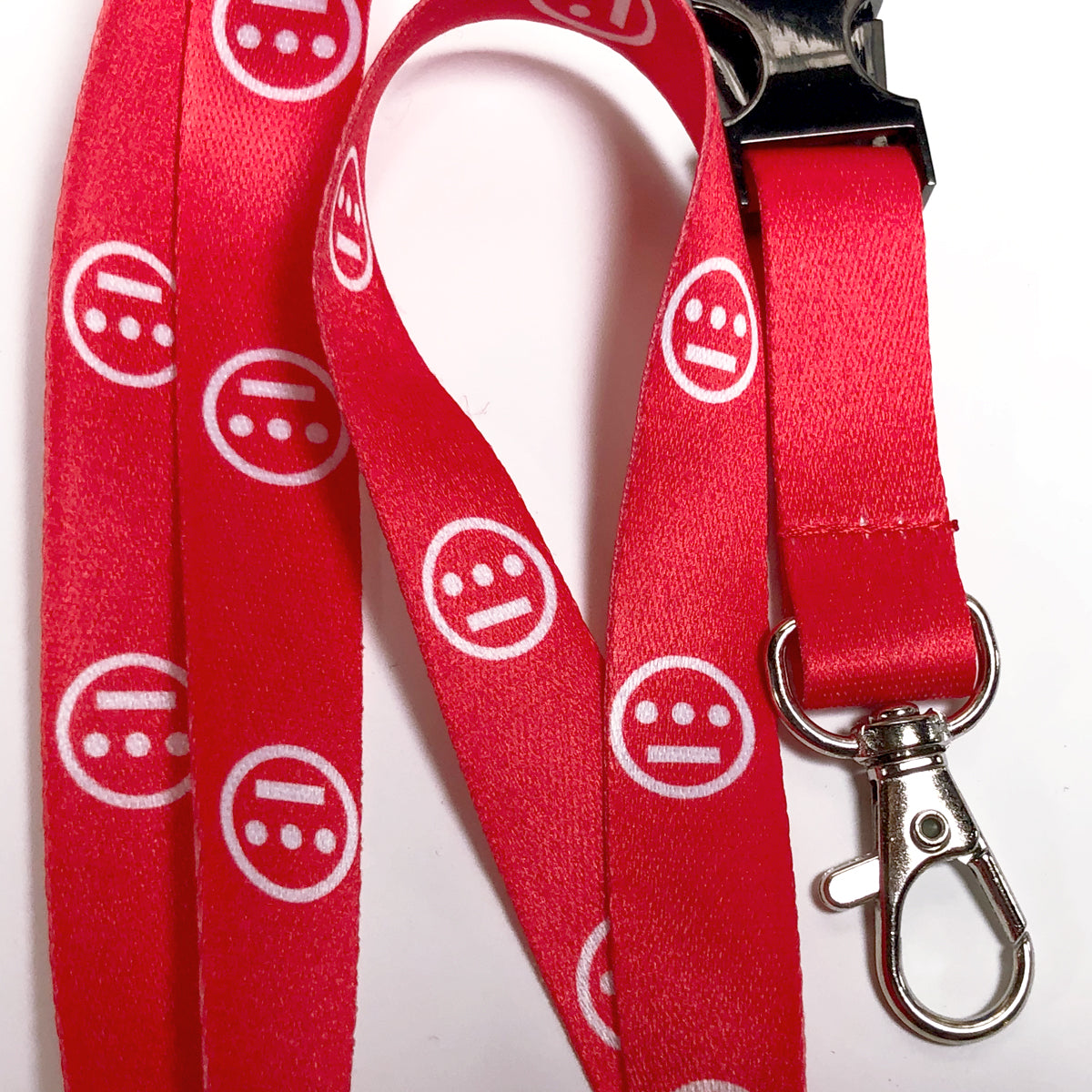 The Hiero VIP Lanyard by Hieroglyphics features a vibrant red strap adorned with a repeating pattern of white, circular logos that showcase three horizontal dots with a single dot on top—an iconic design reminiscent of a hip-hop crew or Hieroglyphics symbol. The lanyard comes equipped with a black clasp and ends in a silver metal hook, ideal for attaching your keychain. It's displayed against a plain white background.