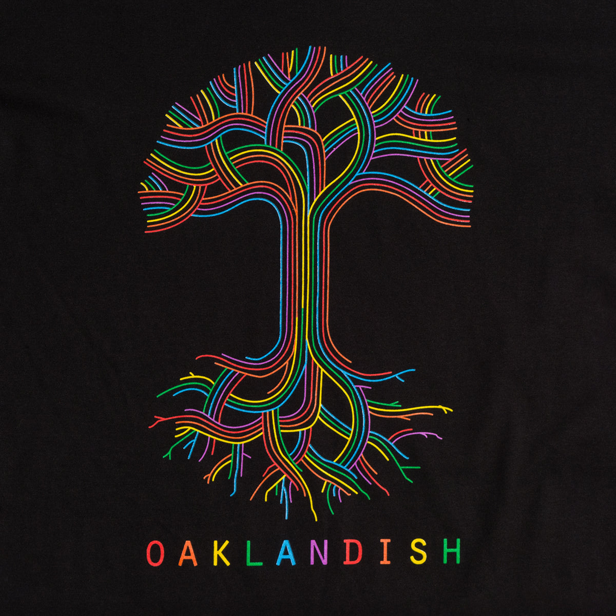 The Oaklandish Pride Classic Logo Tee by Oaklandish features a vibrant, multicolored tree design with lines forming the branches and roots on a black background. Below the tree, "OAKLANDISH" is emblazoned in capital letters, each in a different color that matches the bright hues of the tree's lines. This limited-edition piece celebrates Oakland pride.