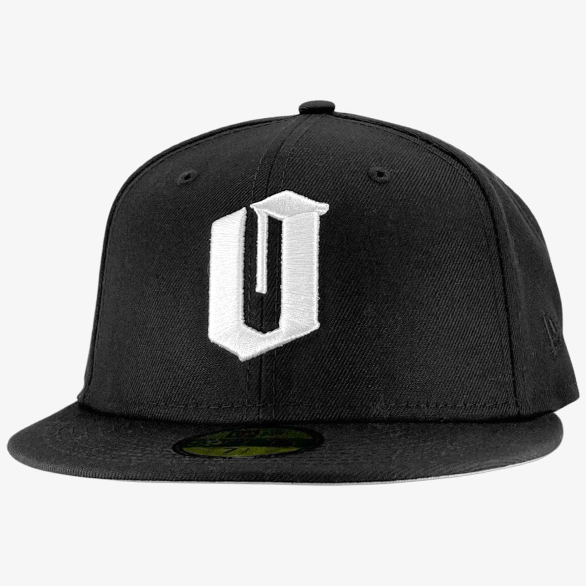 Introducing the New Era Official 59FIFTY Fitted Cap by Oaklandish: a sleek black flat-brim cap with a bold white embroidered letter "U" on the front. This fashionable headwear boasts a recognizable green sticker on the brim and six eyelets on the crown for optimal ventilation, merging simplicity with contemporary style perfectly.