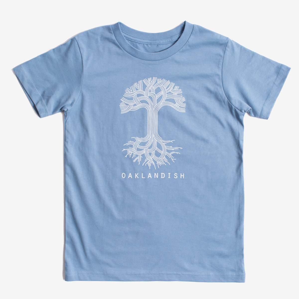 The Youth Oaklandish Classic Logo Tee from Oaklandish is a Carolina blue t-shirt featuring a white graphic of a tree with branching lines resembling roots and branches. Below the tree design, the word "OAKLANDISH" is printed in white. Made of 100% cotton, this youth t-shirt is displayed on a plain white background.