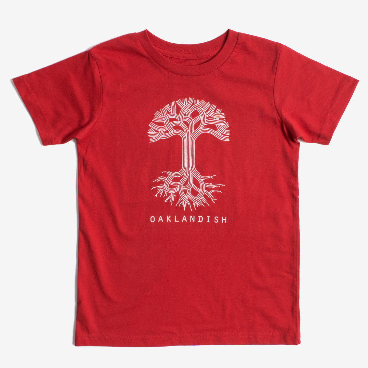 The Youth Oaklandish Classic Logo Tee by Oaklandish is a red T-shirt showcasing a white graphic design of a tree with winding branches and roots in the center. Below the tree graphic, the word "OAKLANDISH" is printed in white capital letters. Made from 100% cotton, this kids' shirt is displayed flat against a plain white background.