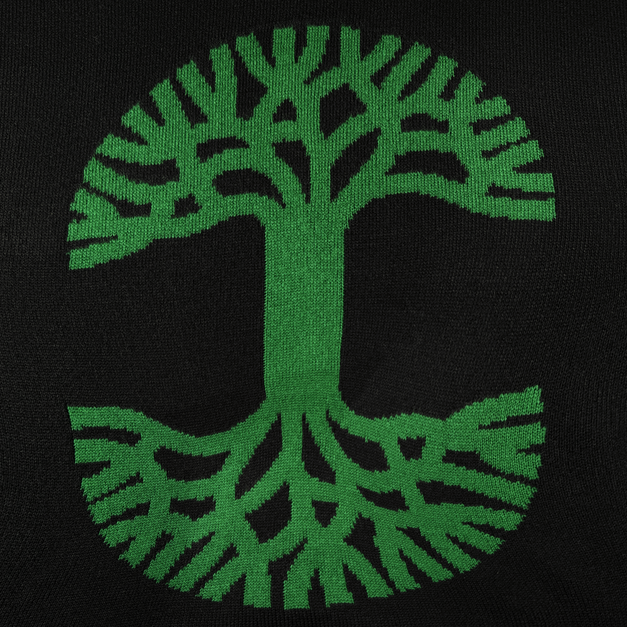 The Oaklandish 2024 Ugly Sweater by Oaklandish features a captivating design of a green abstract tree with branching patterns set against a black background, forming a circular shape reminiscent of a tree canopy, making it an eye-catching piece of outerwear for those seeking standout style.