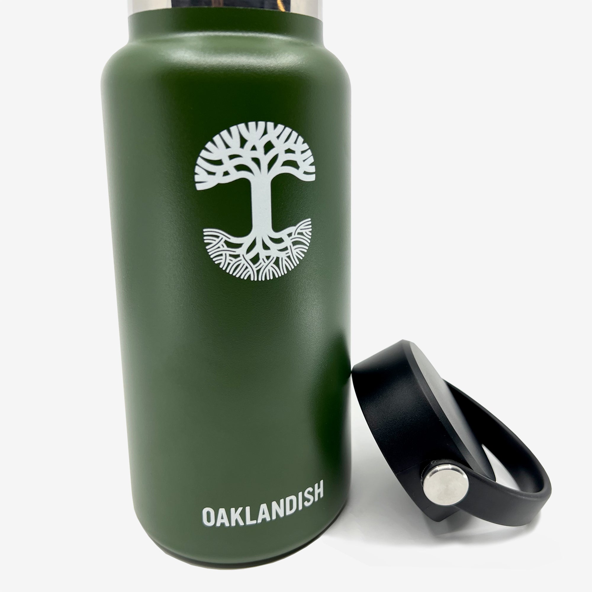 The Oaklandish Canteen is a green, reusable, double-wall insulated bottle featuring a white tree logo on the front and the word "OAKLANDISH" written below. It comes with a black lid that has a handle. Set against a plain white background, this eco-friendly drinkware piece stands out.