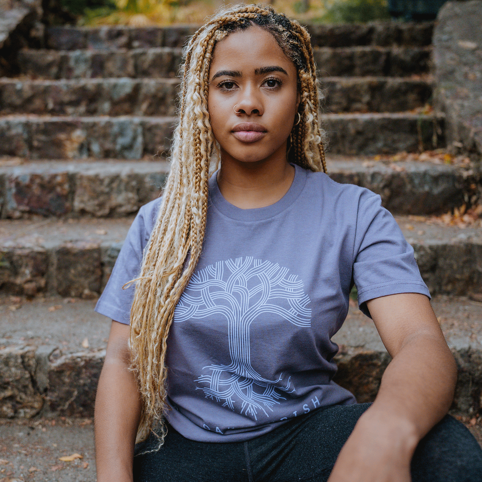 Model wearing Oaklandish classic logo tee mauve.