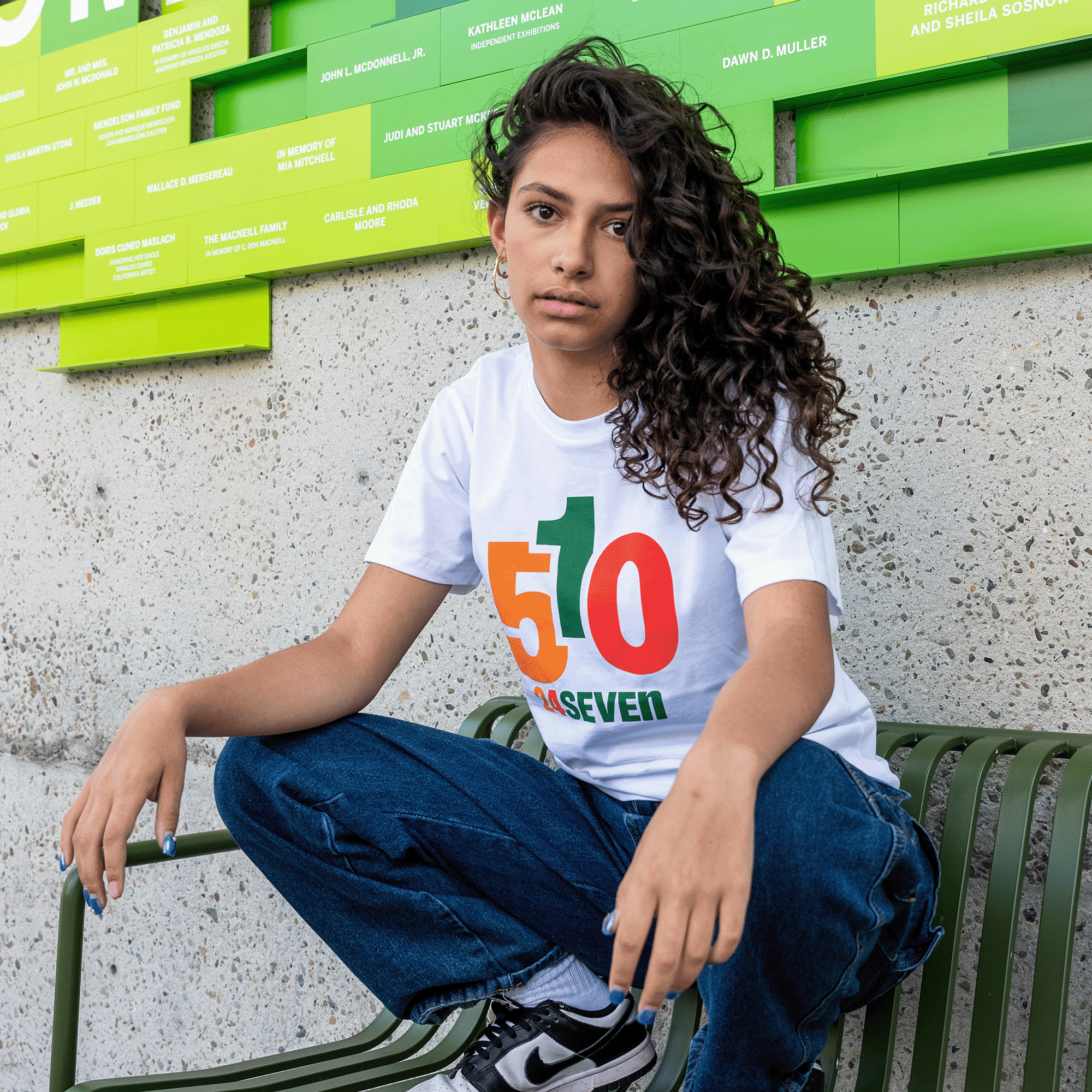 Female model wearing white cotton t-shirt with 510 24 Seven graphic.