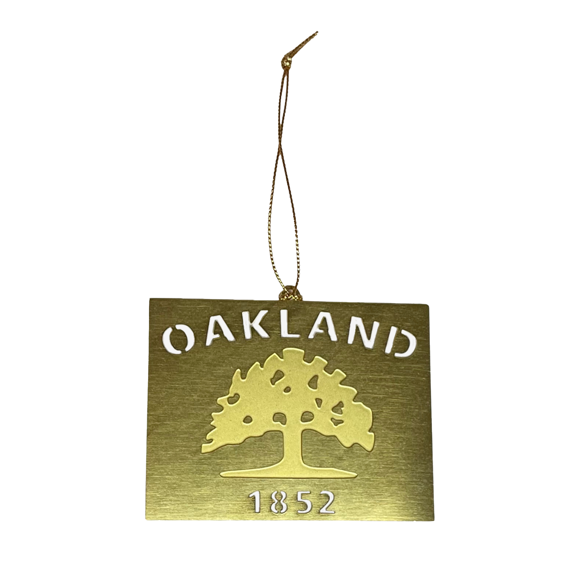 The Oaklandish Oakland Flag Brass Ornament showcases a cut-out design of an oak tree that calls to mind the tree from the Oakland flag. The word "OAKLAND" appears above the tree, with "1852" displayed below it. Ideal for holiday decorations, this ornament comes with a gold string at the top for easy hanging.