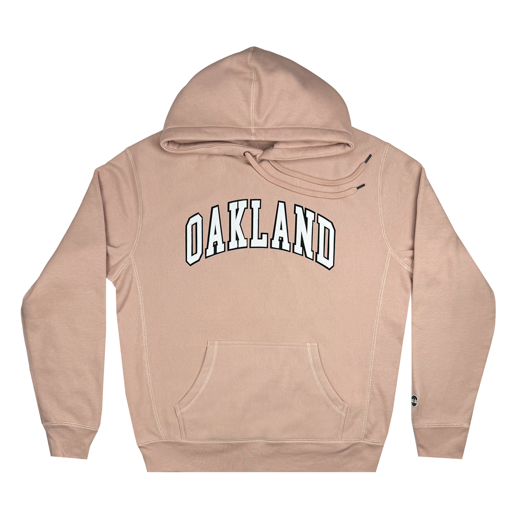 The Alma Mater Heavy Hoodie by Oaklandish is a beige fleece hoodie featuring "OAKLAND" in bold white letters across the chest. It includes a front pocket and adjustable drawstrings on the hood, highlighting its soft and comfortable fabric.