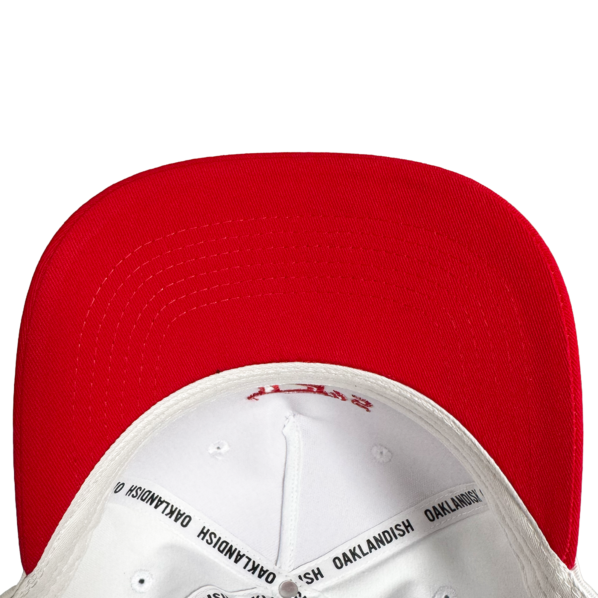 Close-up of the underside of the Oakland Ballers 5 Panel Cap, featuring a red brim and white crown. Black “OAKLANDISH” taping details the interior—a stylish nod to Oakland Ballers baseball. Plain white background.