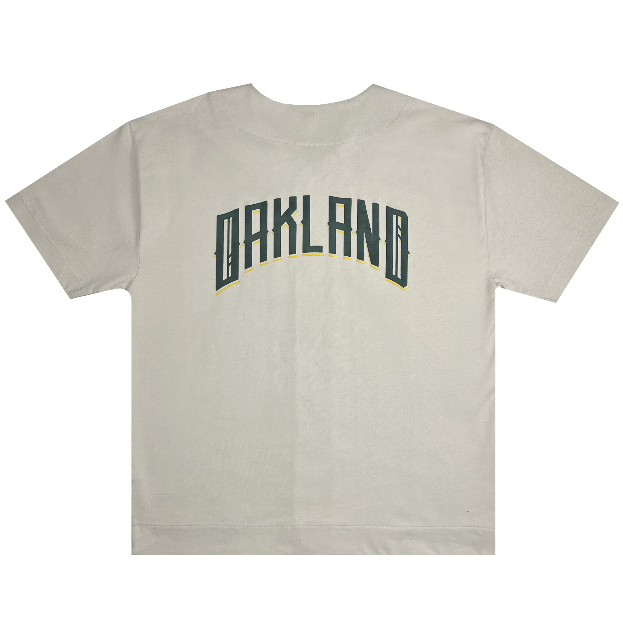 Oakland Ballers Heavy Baseball Jersey: This beige jersey features "OAKLAND BALLERS" printed in large, green, block letters with yellow outlines across the back, representing the professional baseball team. The text is arched slightly upward. The jersey is laid flat against a white background.