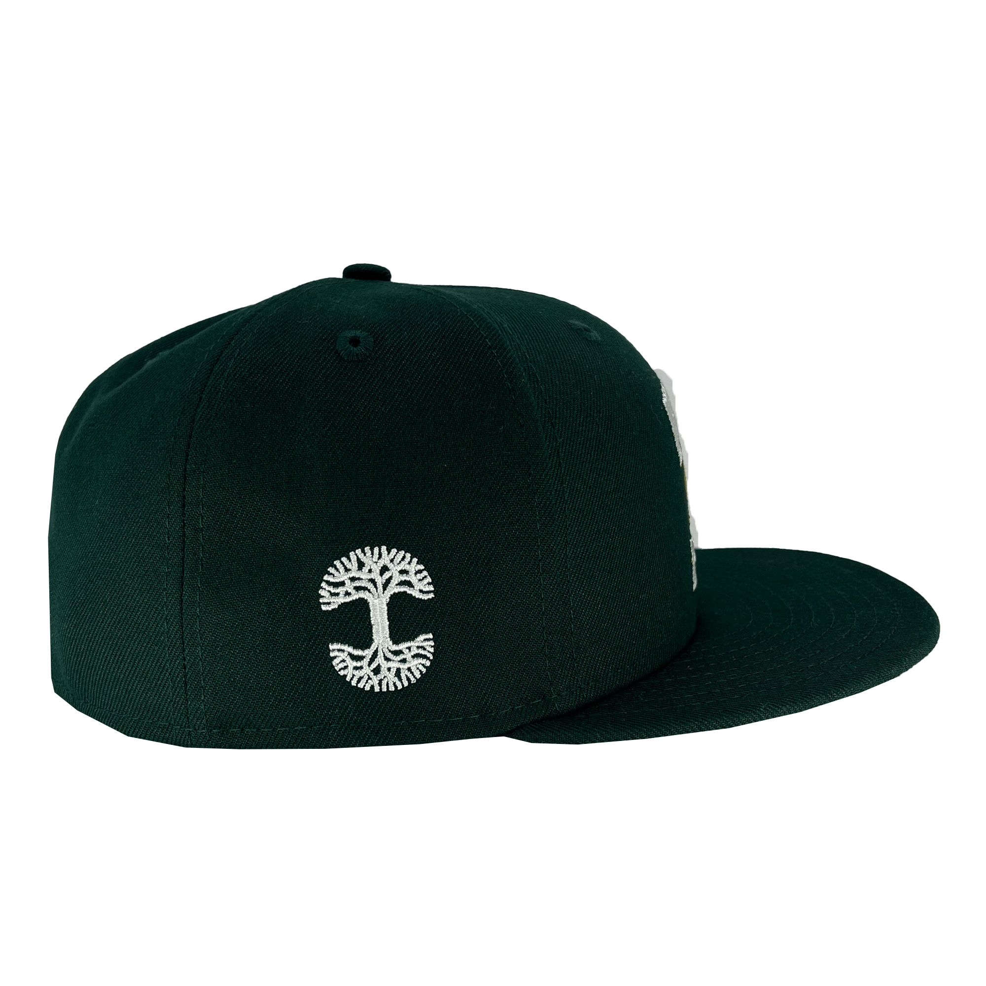 A dark green New Era Oakland Ballers Alt. Logo 59FIFTY Cap viewed from the side showcases a white embroidered abstract tree design on the side panel, representing the Oakland Ballers. The cap is structured with a flat brim and a high crown, standing out against its solid white background backdrop.