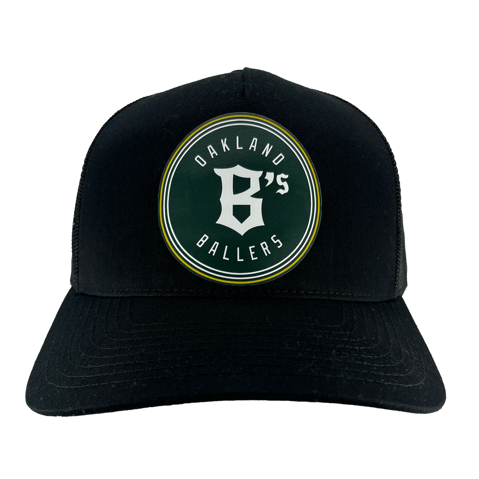 The Oakland Ballers Classic Curved Visor Trucker by Oakland Ballers is a black baseball cap featuring a circular green and white patch on its front. The patch reads "Oakland Ballers" with a prominent white "B" at the center, representing the Oakland baseball team in the Pioneer League. The patch is bordered by two thin yellow lines. The cap also has a curved brim and mesh sides and back.