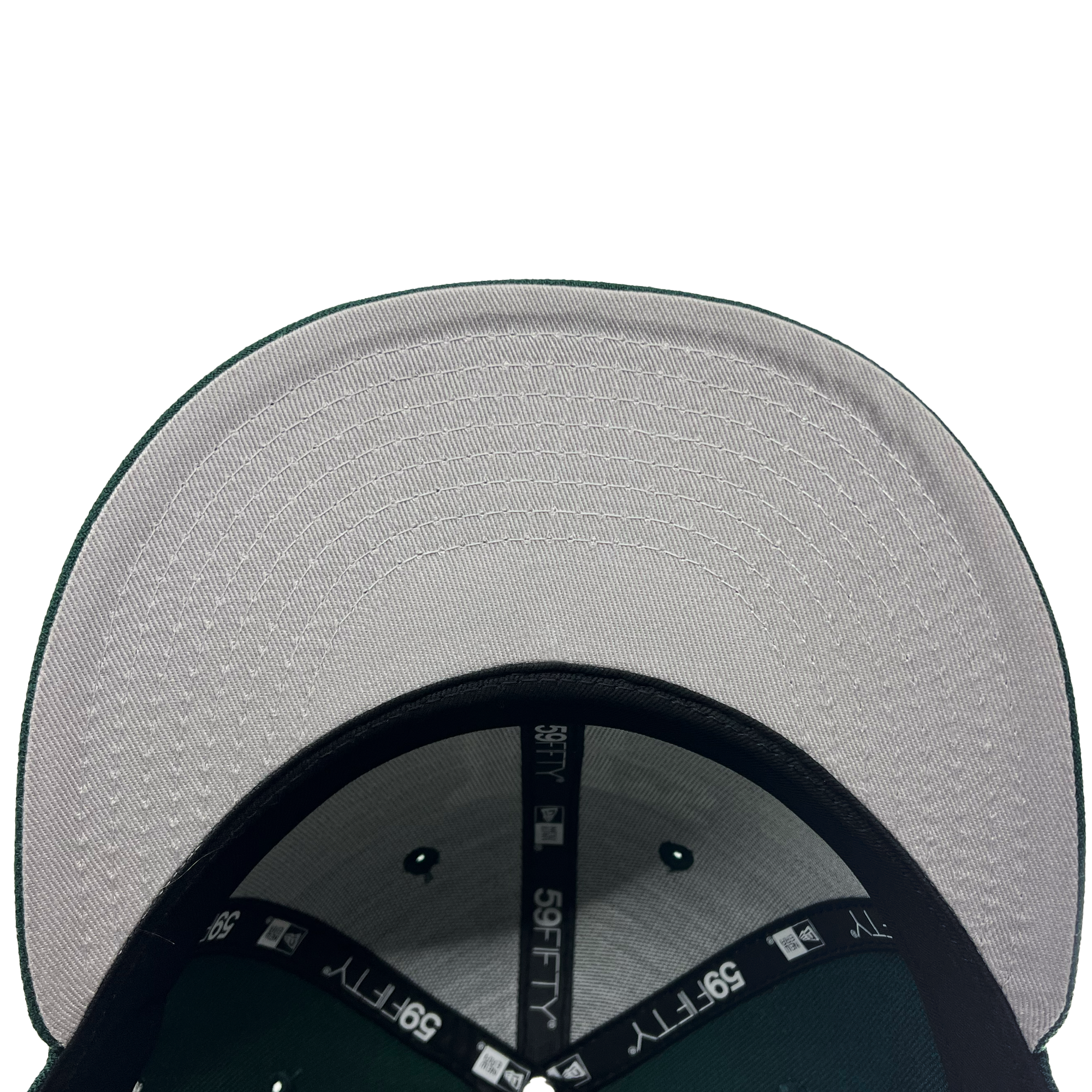 The image displays the underside of a New Era Oakland Ballers Low Profile 59FIFTY Cap, featuring a green and gray design typical of an Oakland Ballers player's attire. The top panel is gray with stitched seams, bordered by green edges. Inside, black lining tape is adorned with "59FIFTY" and the New Era logo in white. The background is plain white.