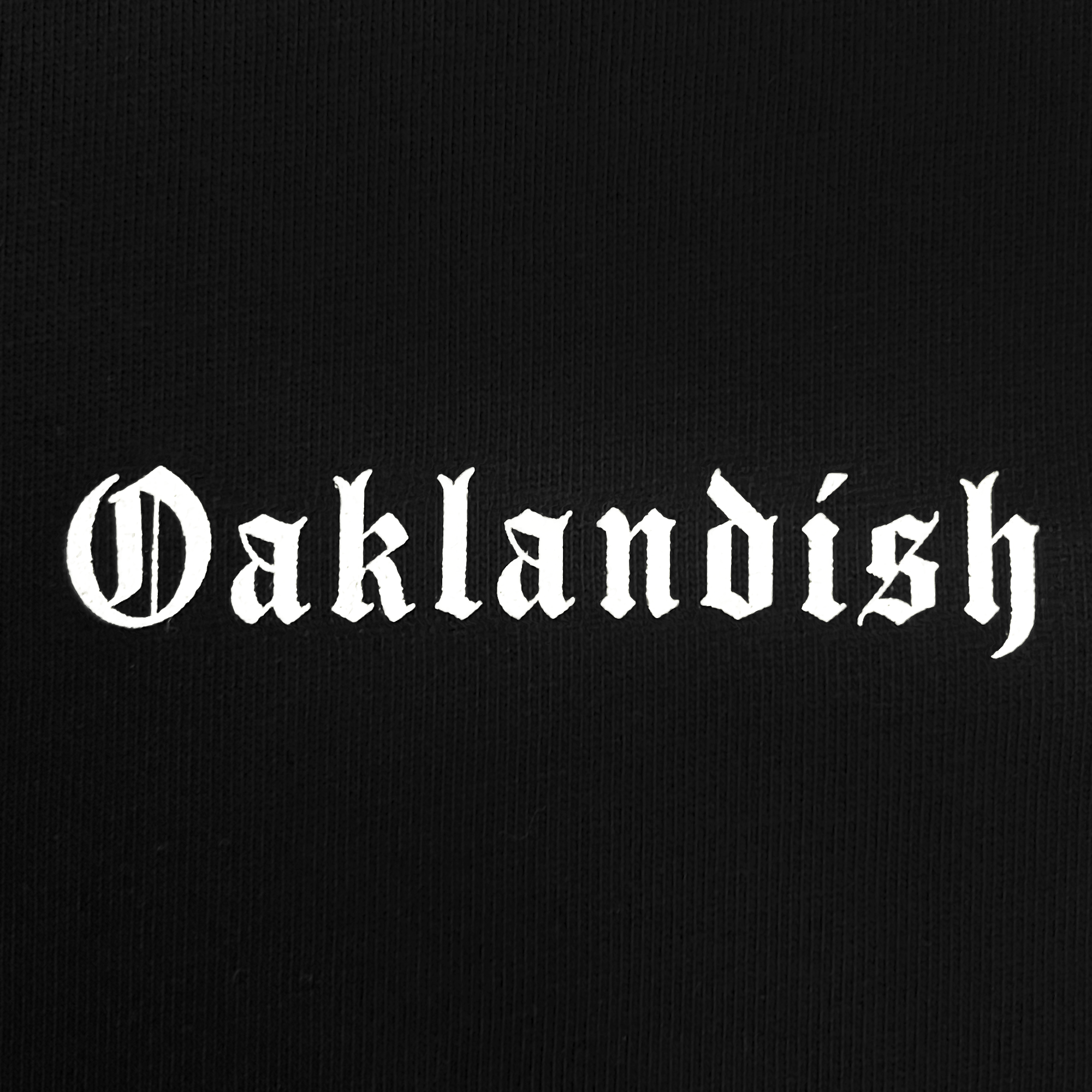 The image showcases the Oaklandish Heavy Button-up Baseball Jersey, featuring the word "Oaklandish" in a white, gothic-style font against a black backdrop with the iconic Oaklandish tree logo.