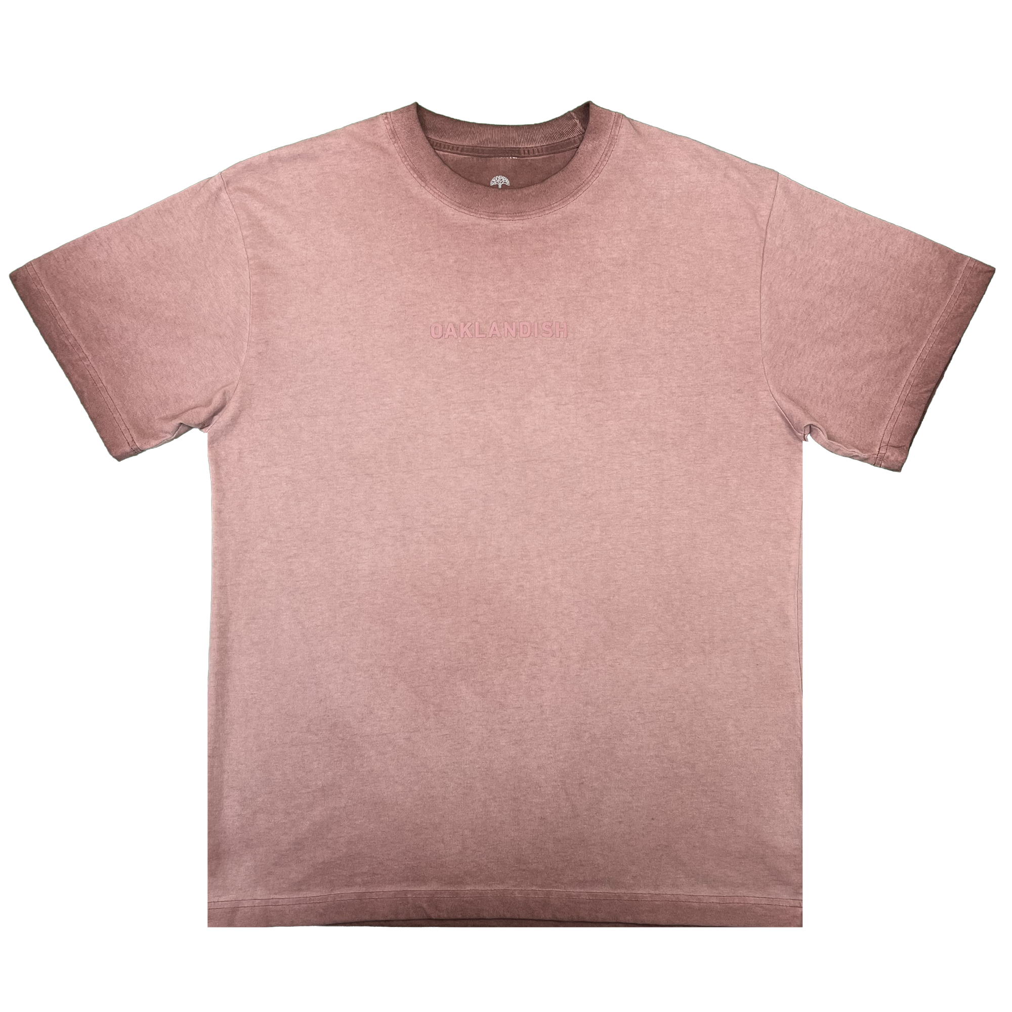 The Oaklandish Classic Logo Tee by Oaklandish is showcased laid flat on a white background. This short-sleeved men’s T-shirt, crafted from heavyweight cotton, features a crew neckline and subtle embossed “OAKLANDISH” text across the chest. The mauve fabric offers a lightly faded, vintage look.