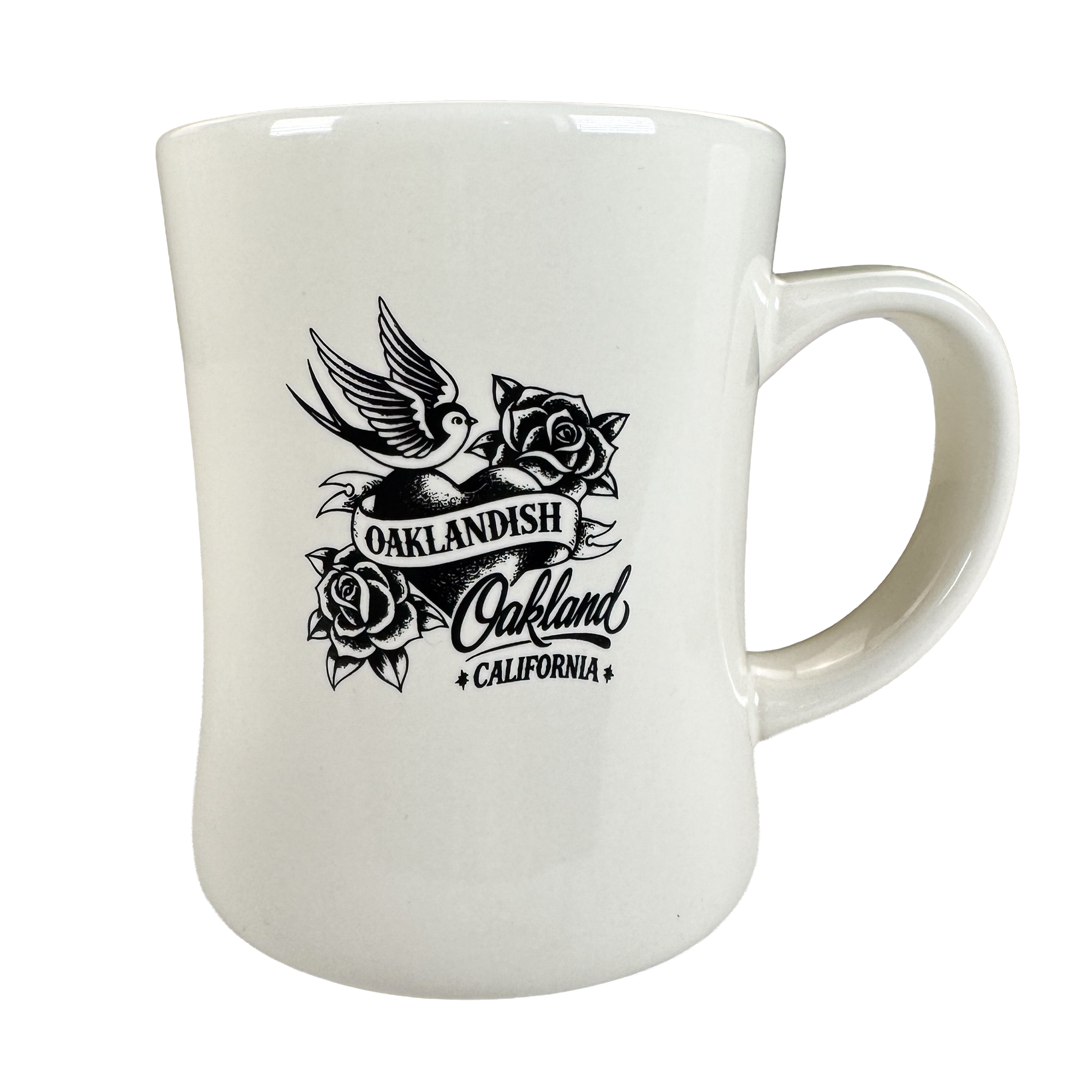 The Heart Diner Mug by Oaklandish is a white 14 oz ceramic mug with black flying bird artwork above an “OAKLANDISH Oakland CALIFORNIA” banner, framed by roses. It features a curved body and large handle for comfortable use.