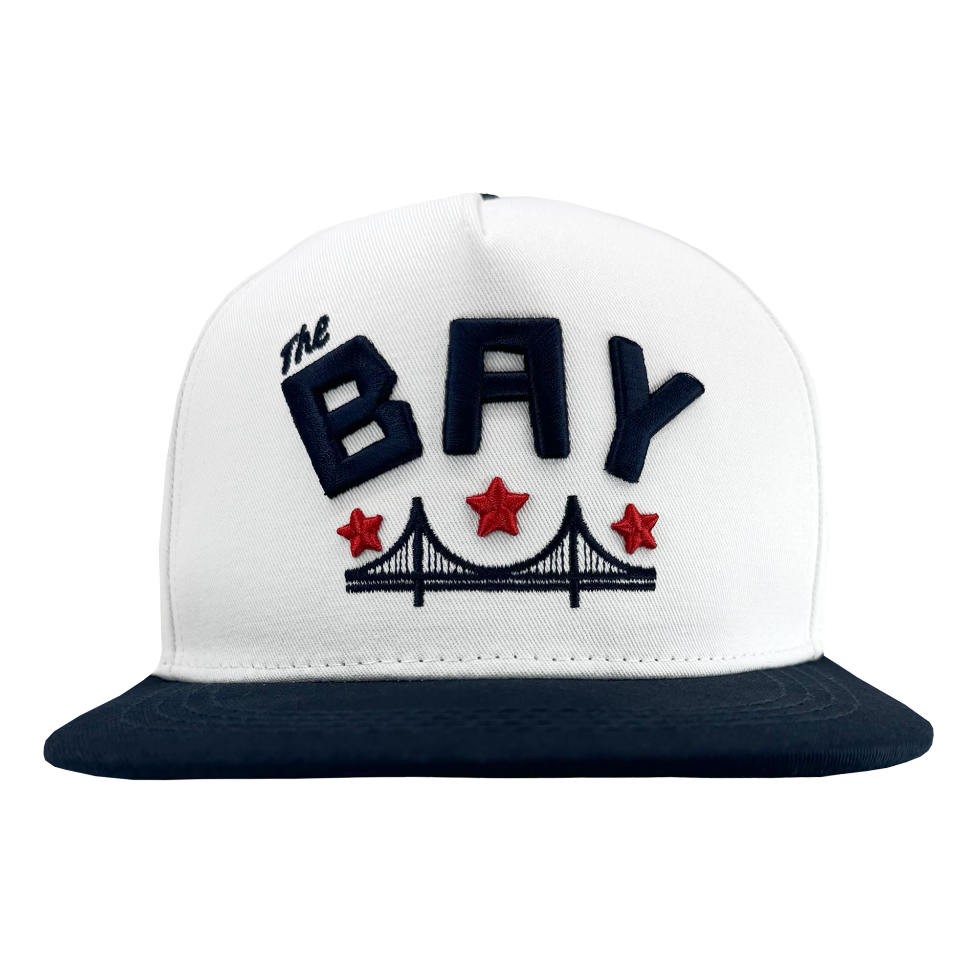 The Bay Bridge Snapback by DOC from Oaklandish is a white cap with a black brim, showcasing Bay Area culture. It features bold navy "THE BAY" text on the front, accompanied by an embroidered black suspension bridge silhouette and three red stars.