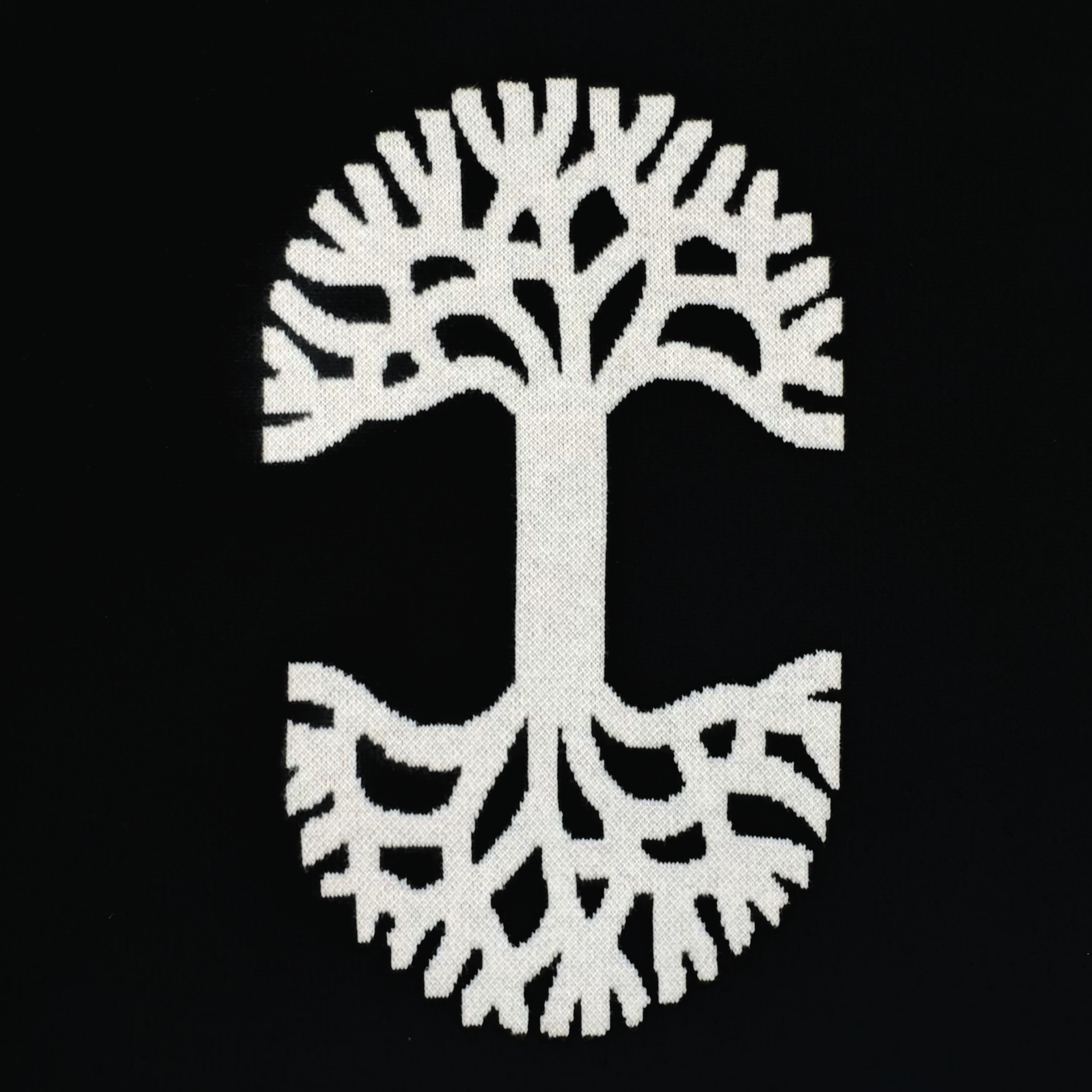 The Oaklandish Ease Jersey features a white stylized tree with large limbs and mirrored roots on a black background, creating a classic, symmetrical design in unisex sizing.