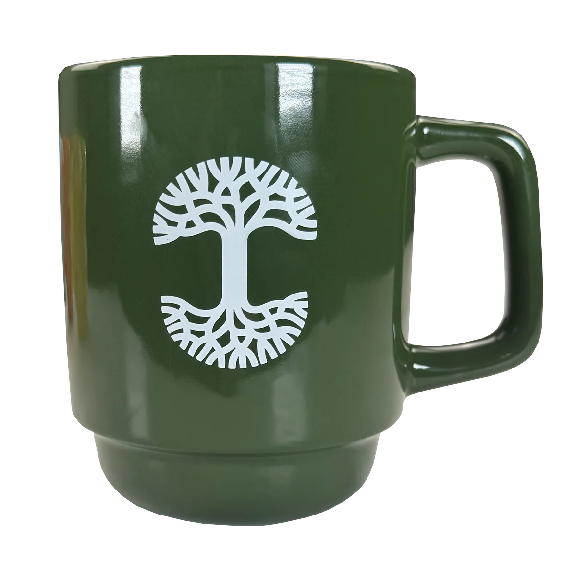 The Oaklandish Logo Stack Mug is a glossy green ceramic mug with a large handle and a white tree design. Its mirrored branches and roots stand out, while the stackable design adds style and practicality. Perfect for any kitchen.
